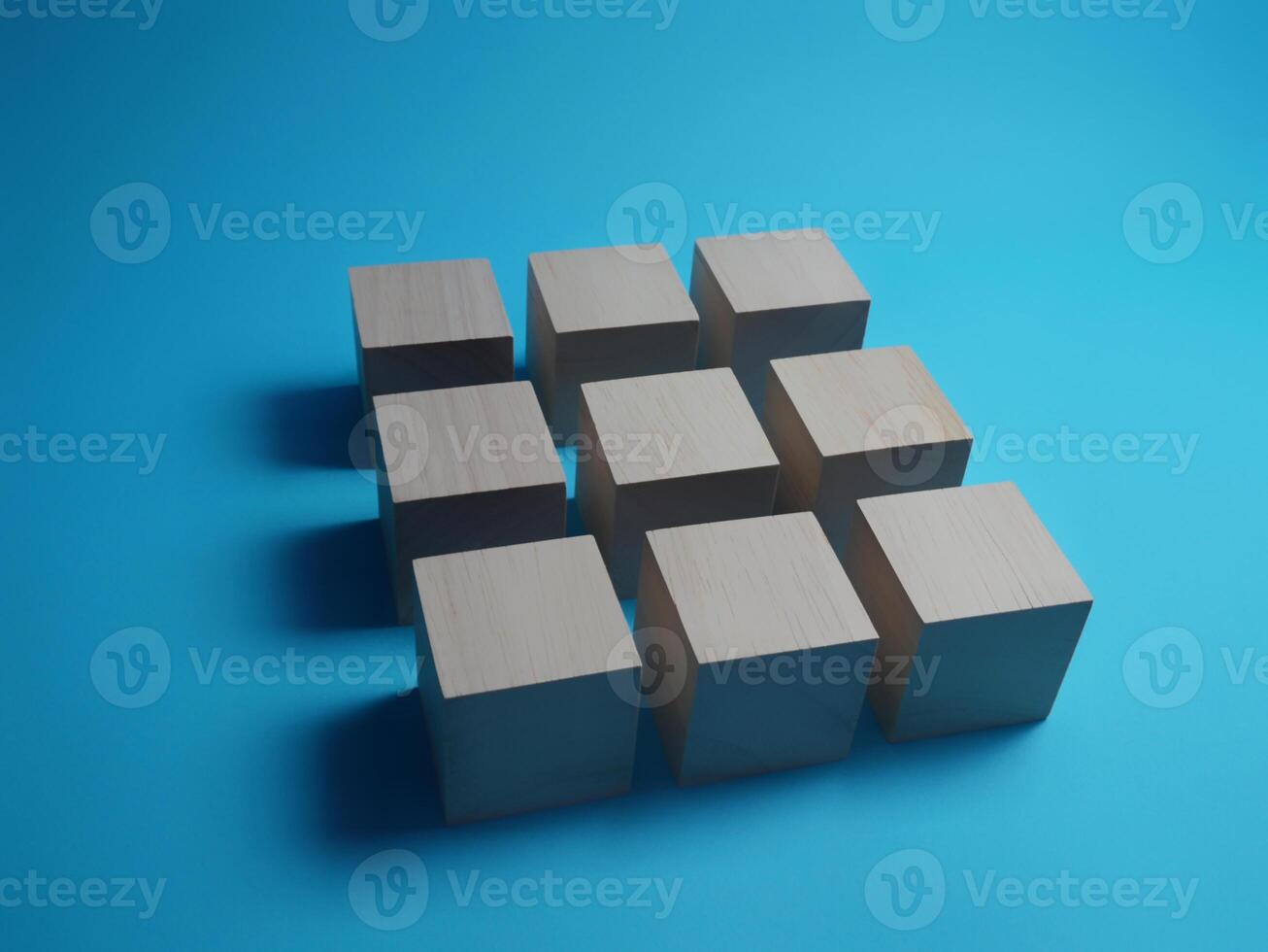 Cubes arranged in a square shape on a blue background photo