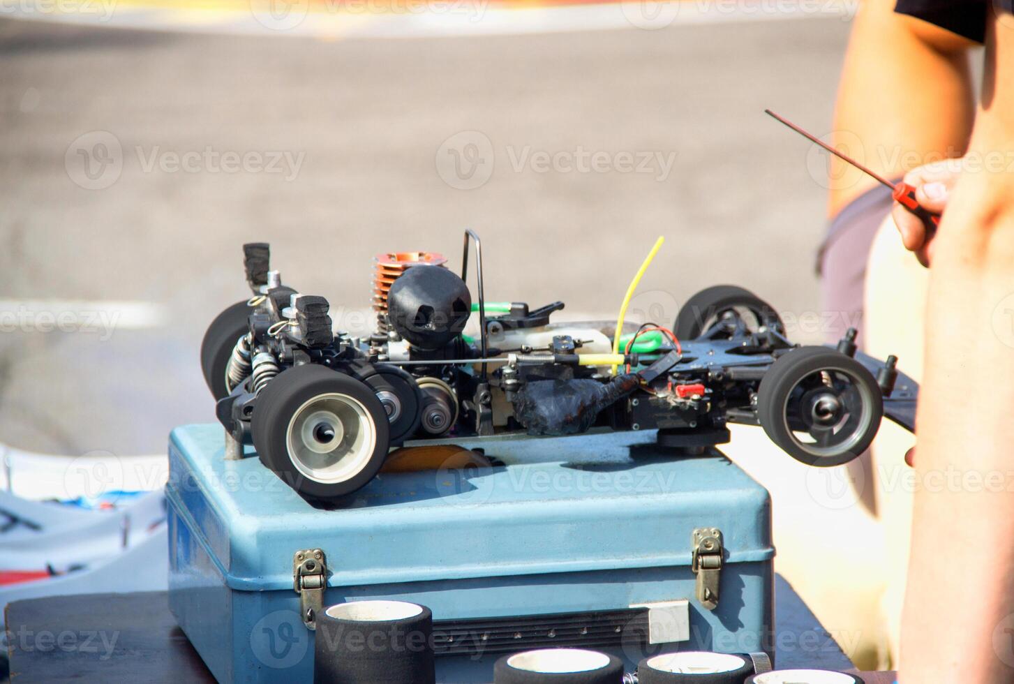 Setting up a radio-controlled car model with a gasoline engine. Motorsport, championship photo