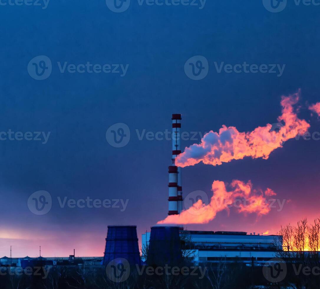 thermal power plant against the background of an evening solar sunset and a blue sky, steam comes from the pipes of the plant. Copy space for text photo