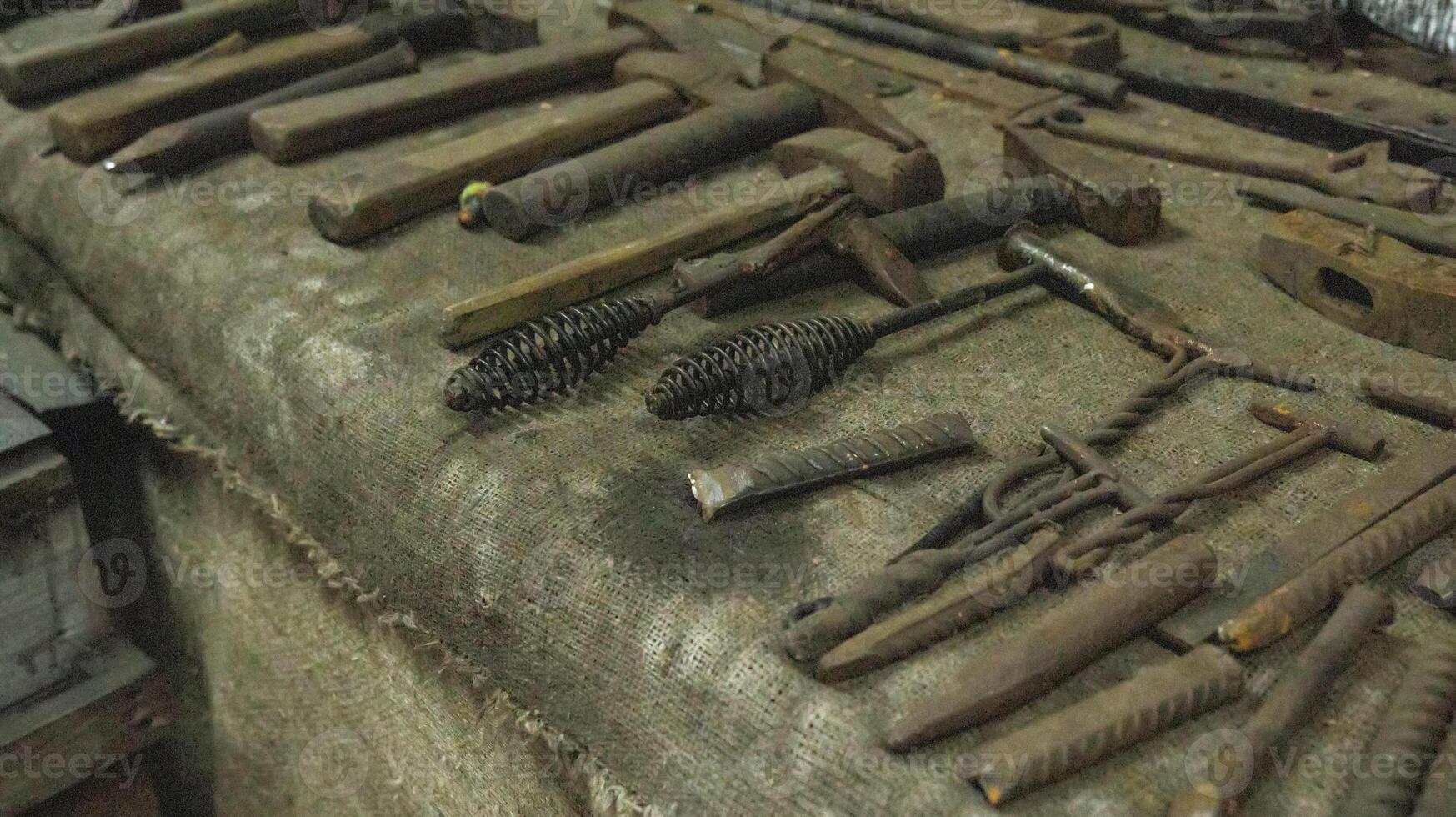 Lots of metal tools to work in the forge. Background, industry. photo
