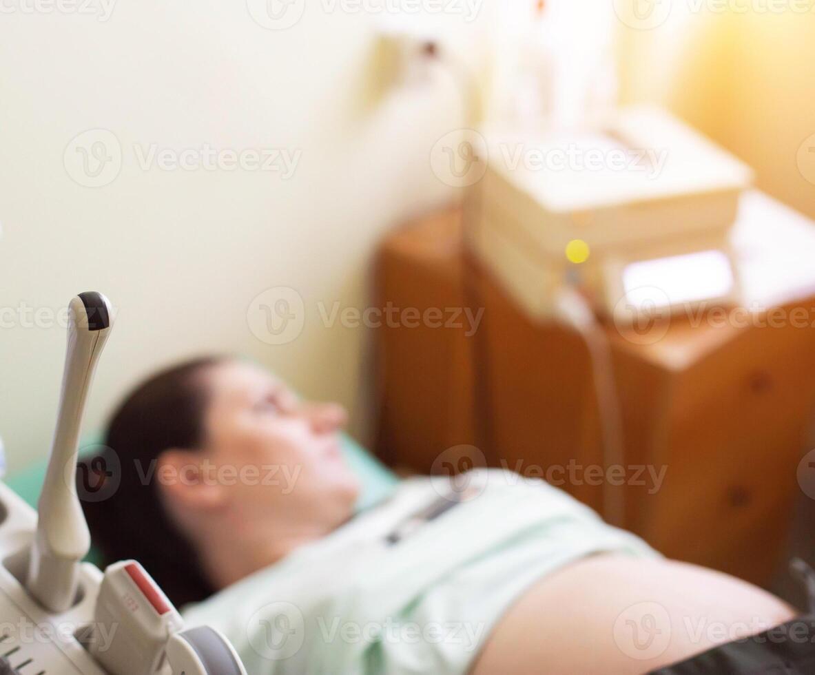 Pregnant girl on ultrasound examination in the third trimester. Examination of the amount of amniotic fluid, entanglement of the umbilical cord of the child. Copy space for text photo