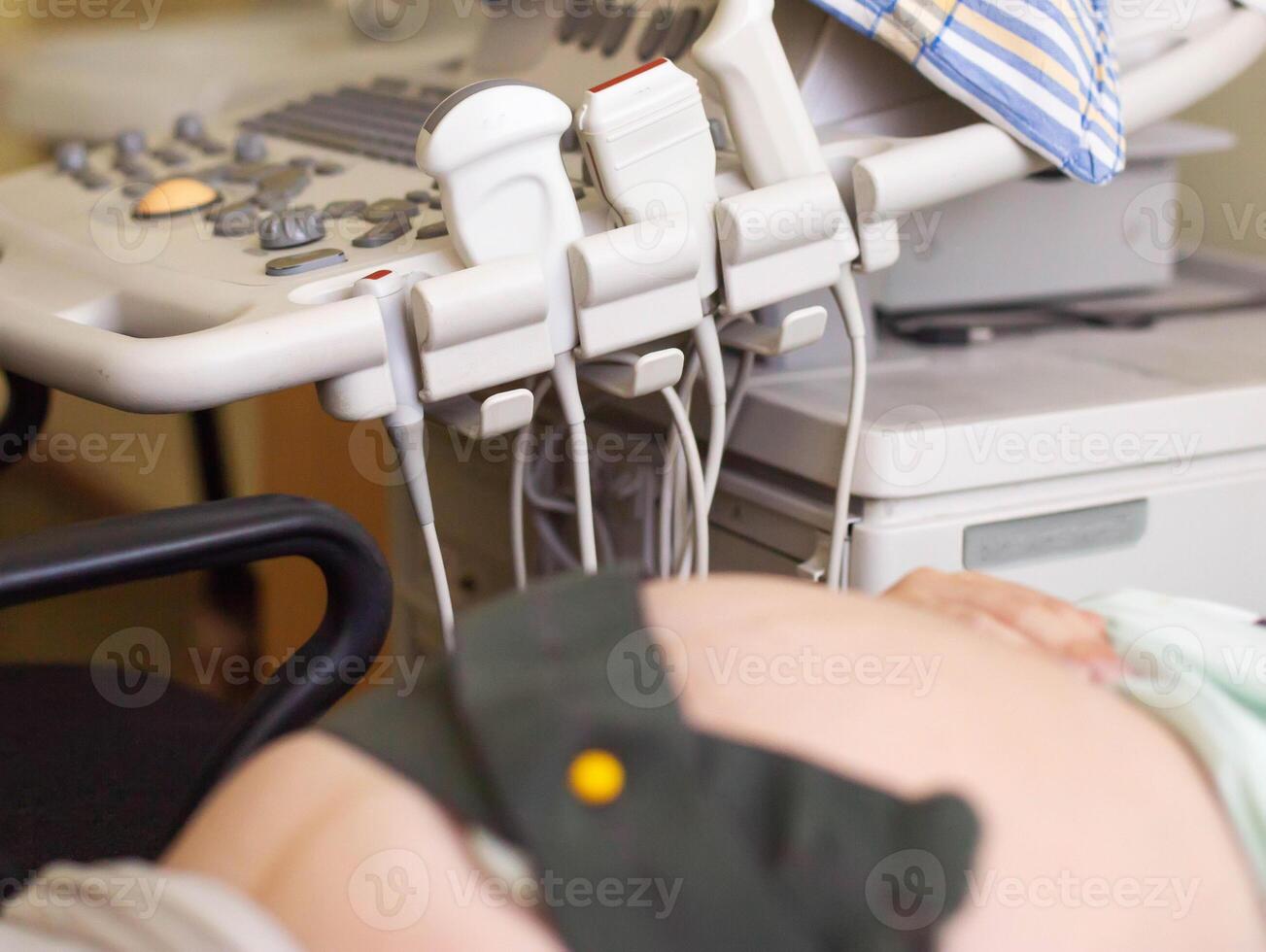 A pregnant woman undergoes a medical examination. Cardiotocography for an infant. A method of functional assessment of the state of the fetus during pregnancy and childbirth photo
