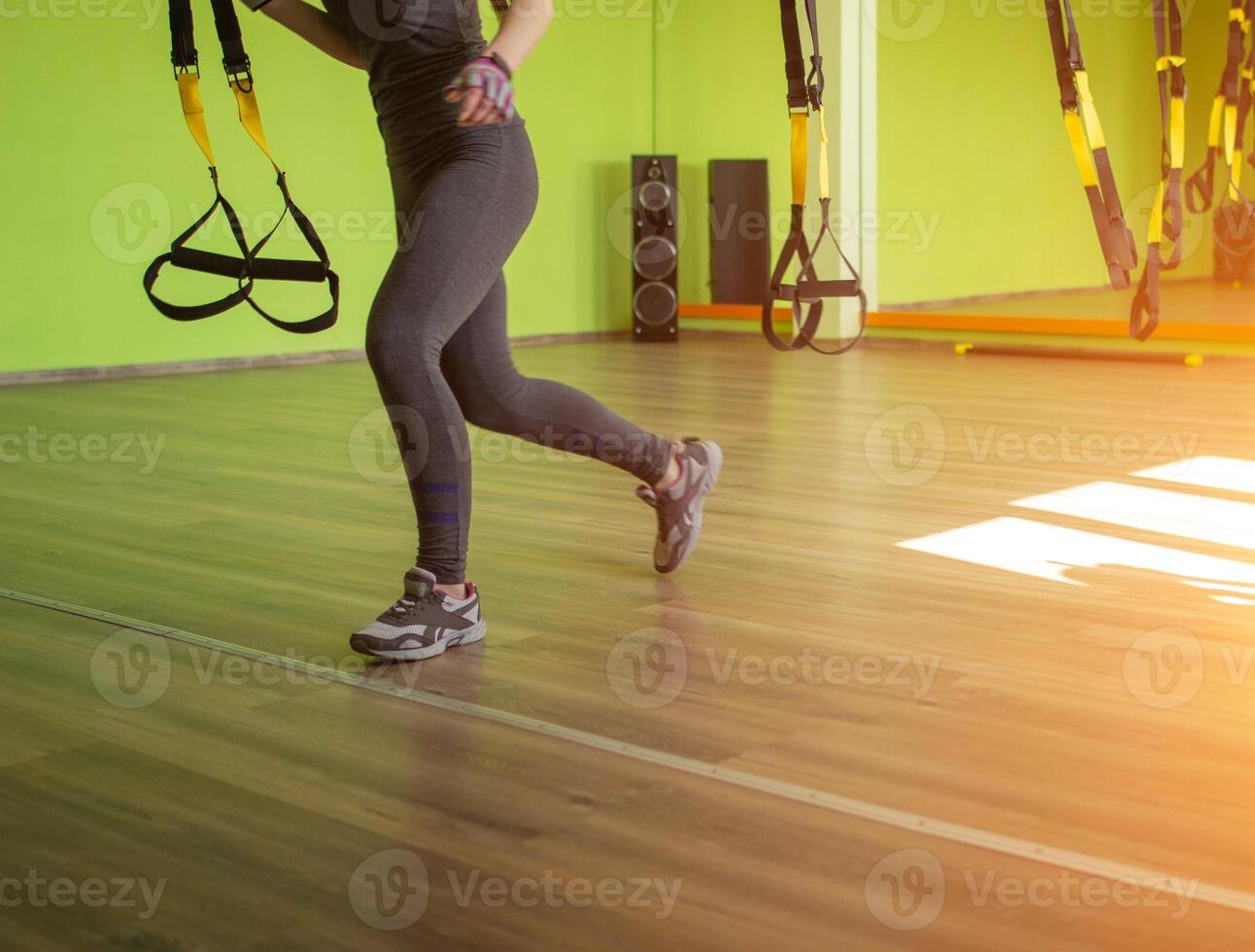 Lesson and exercise in a modern gym with loops, copy space, sun, excess weight, metabolic photo