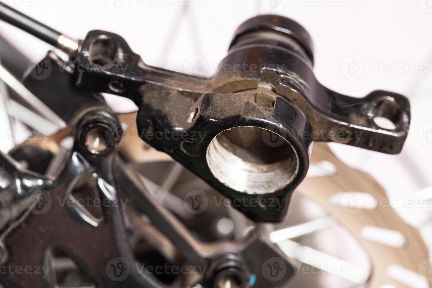 A disassembled bicycle caliper for its maintenance and replacement of brake pads on a disc brake system. photo