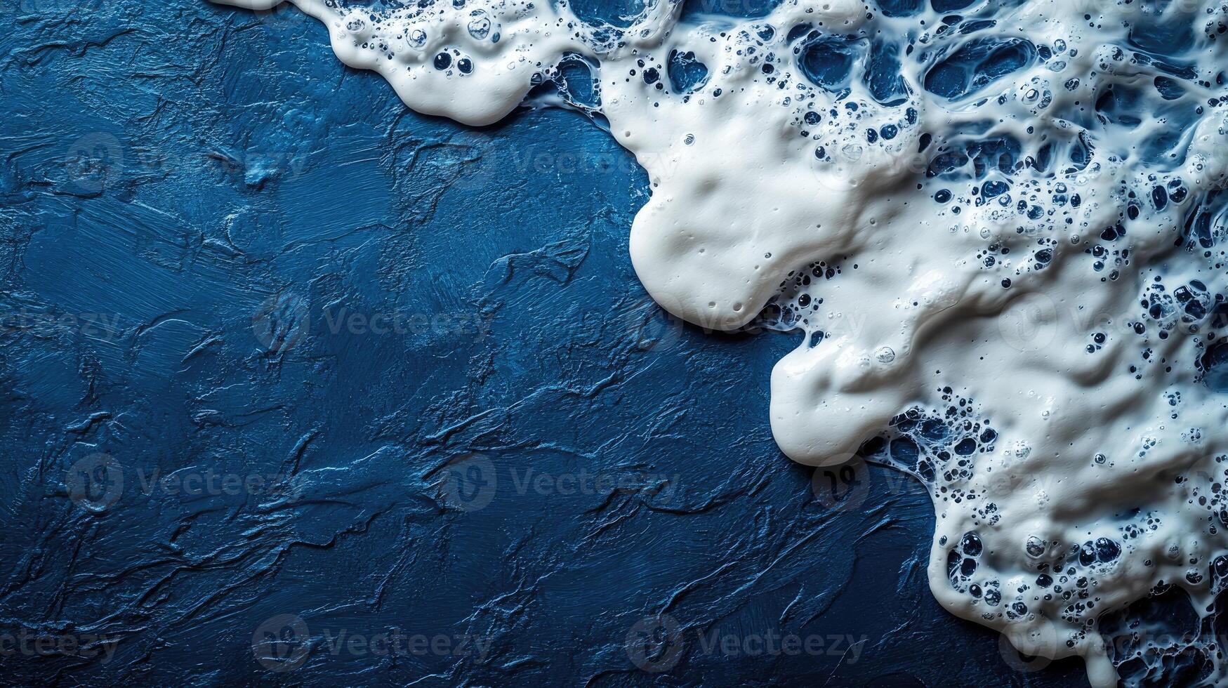 Foamy white waves spill over a deep blue surface, evoking the serenity of the ocean at dusk photo