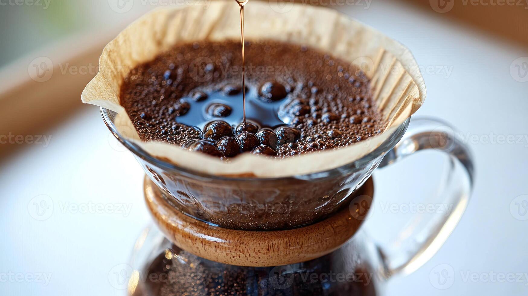 Drizzling hot water over freshly ground coffee in a rustic brew setup photo