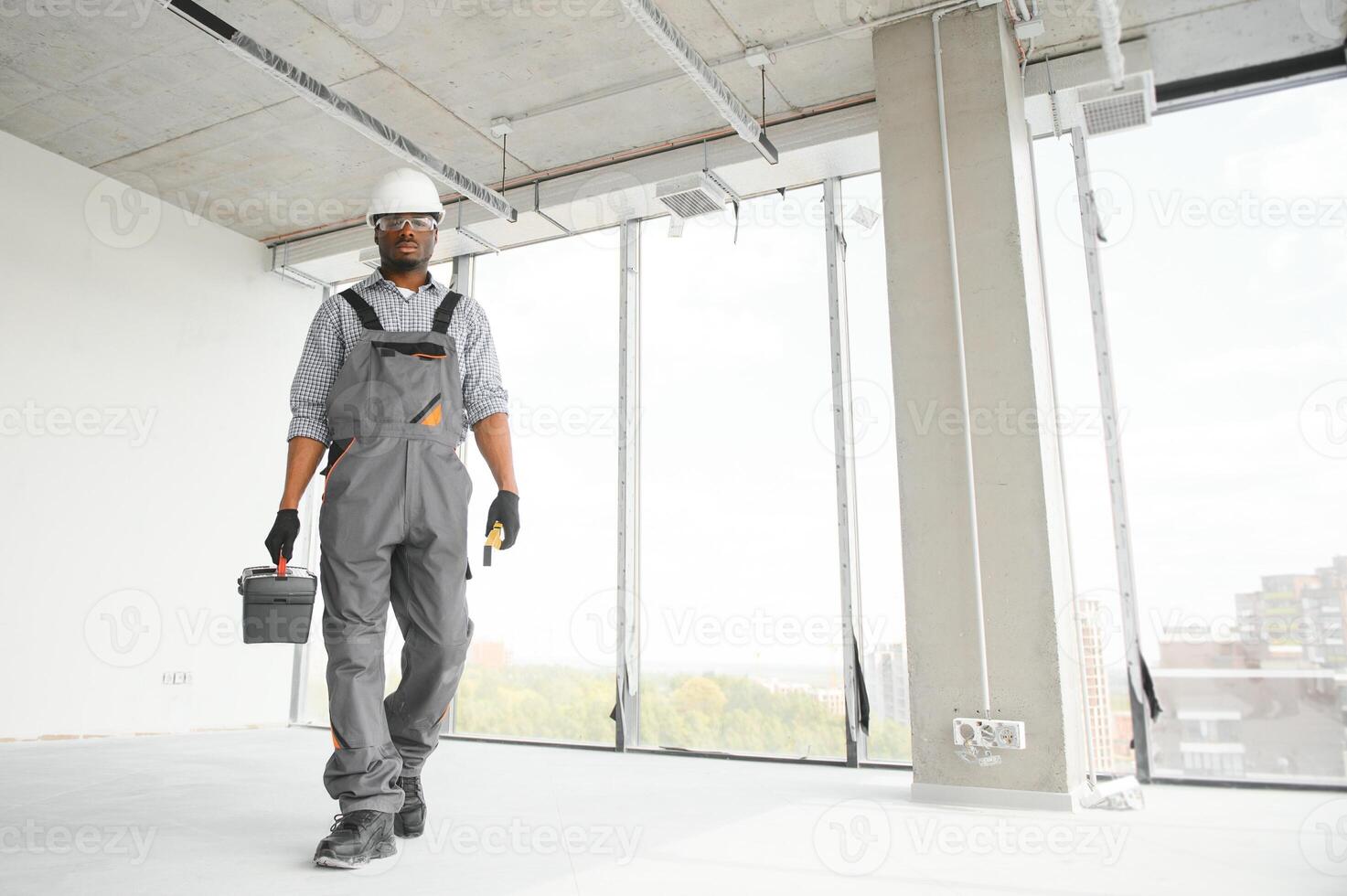 Construction worker in new house. Renovation background photo