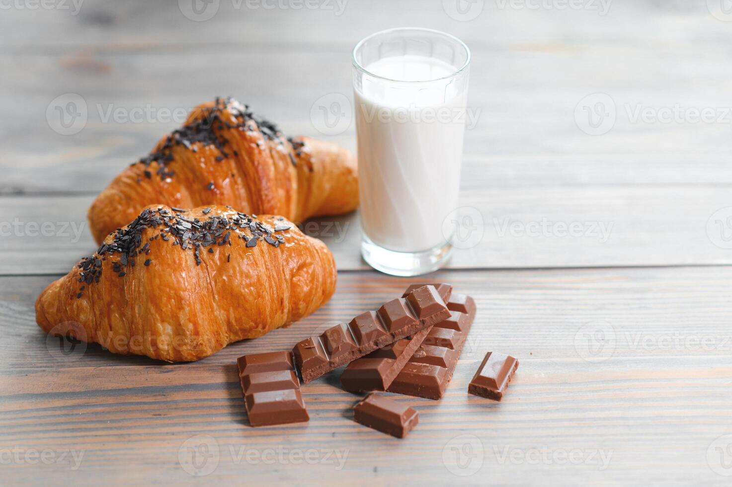 several milk chocolate and chocolate croissants with a glass of milk photo