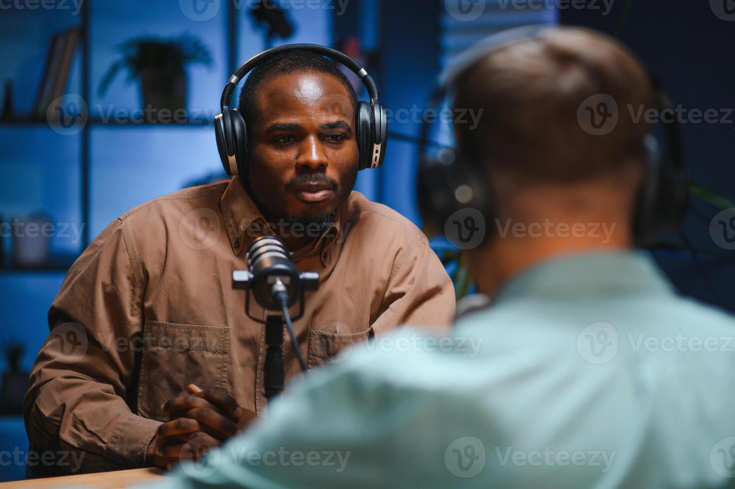 Podcast presenter having live discussion with man, streaming it for audience on internet entertainment show. Influencer enjoying chat with guest photo