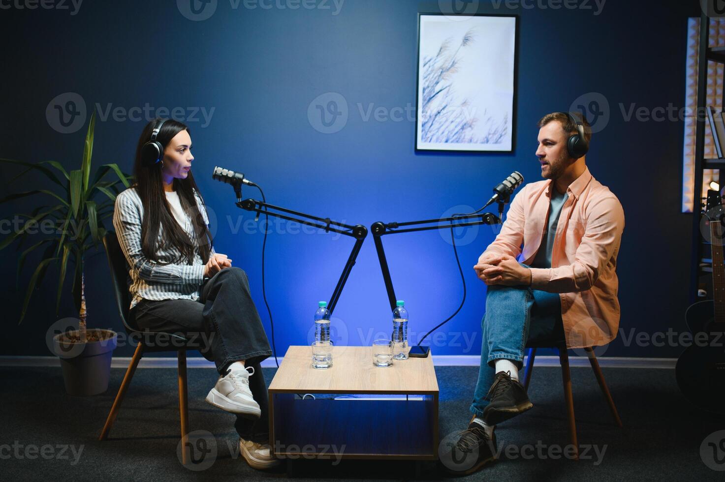 Show host interviewing woman during live stream, talking about fashion and style trends, disagreeing with her opinions. Man arguing with social media celebrity, recording podcast photo
