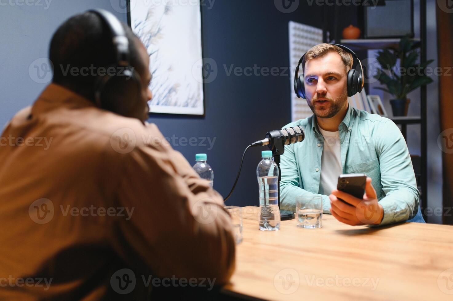 Podcasters enjoying happy conversations with online listeners in studio, covering wide range of subjects photo