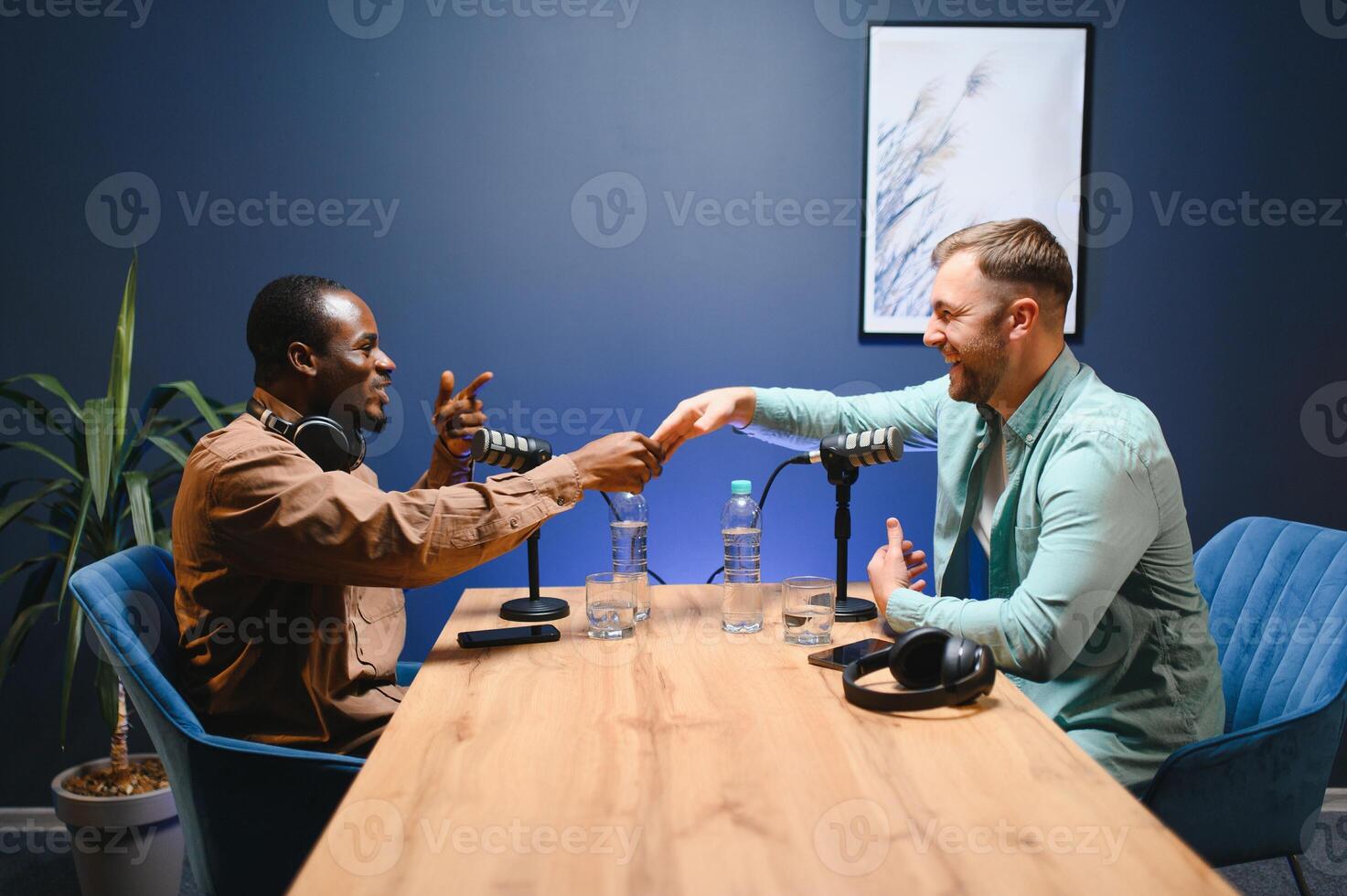 Podcasters shake hands after a good talk. Concept of podcasts and vlogs photo