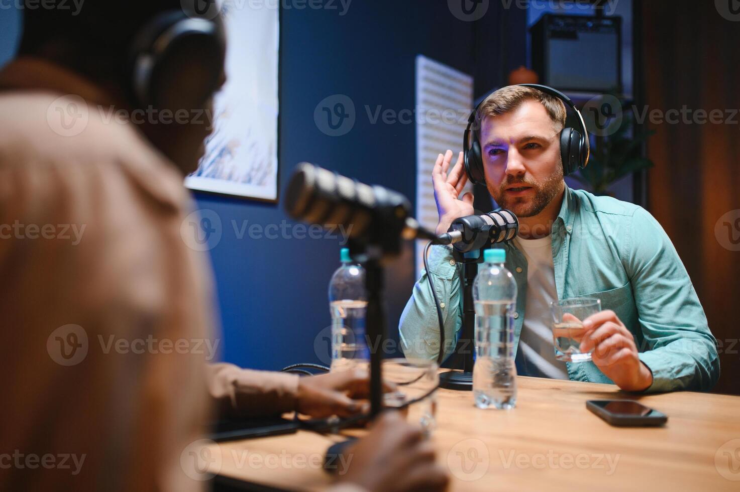Podcasters enjoying happy conversations with online listeners in studio, covering wide range of subjects photo