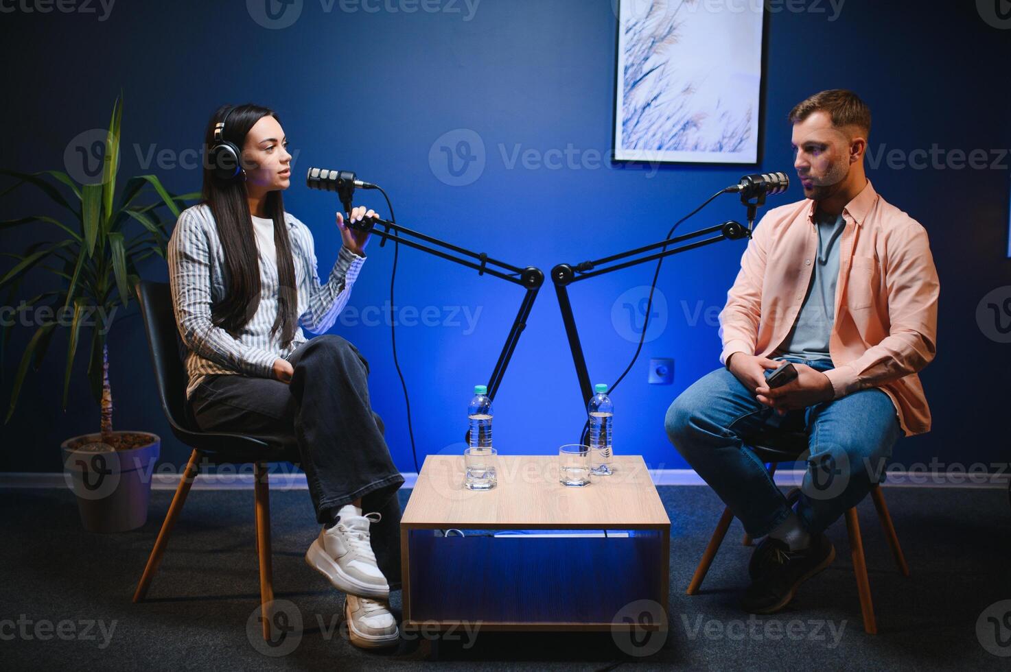 Show host interviewing woman during live stream, talking about fashion and style trends, disagreeing with her opinions. Man arguing with social media celebrity, recording podcast photo