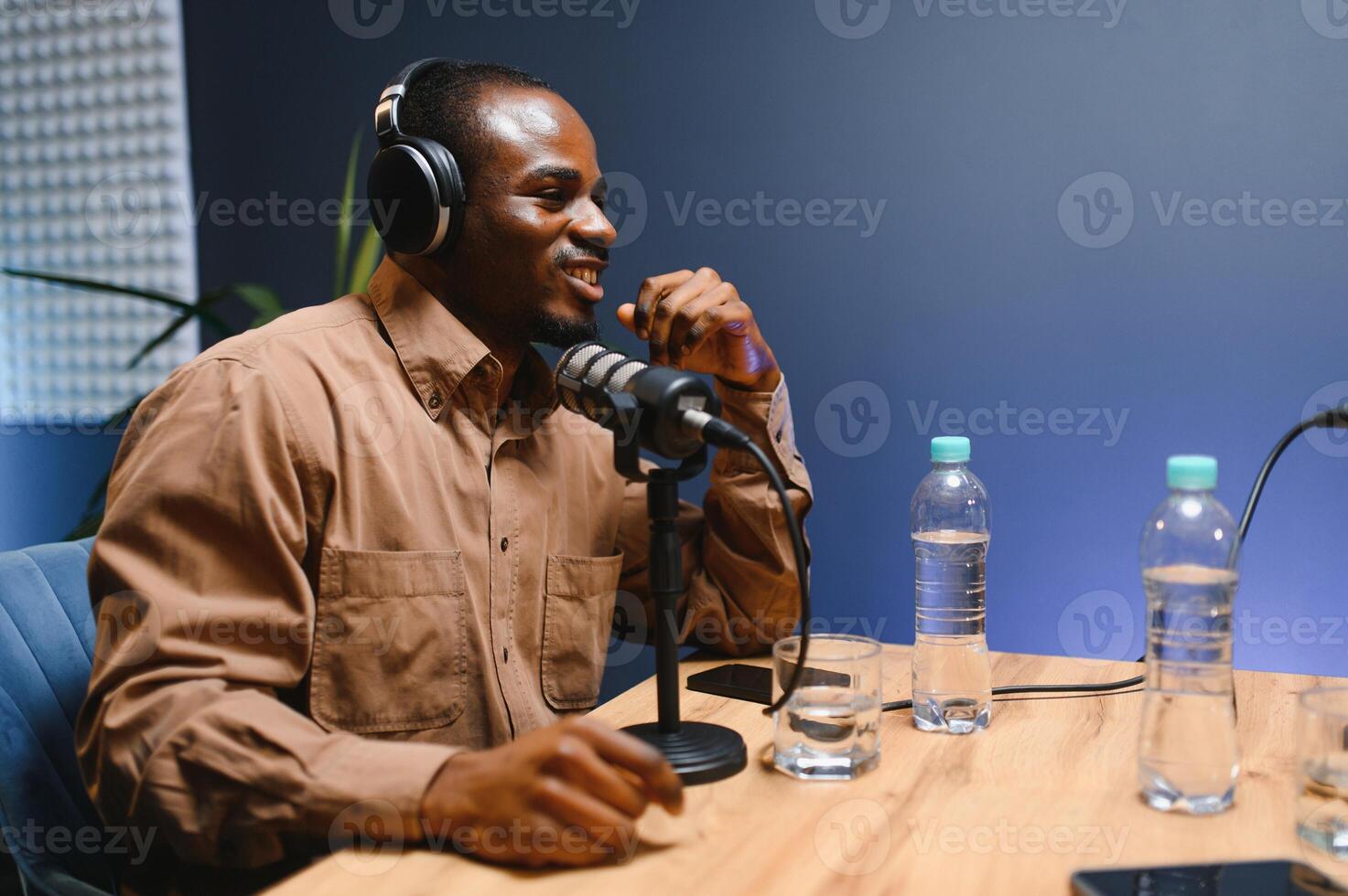 Man recording podcast using high tech microphones to interview guest, ensuring flawless and sound quality for audience photo
