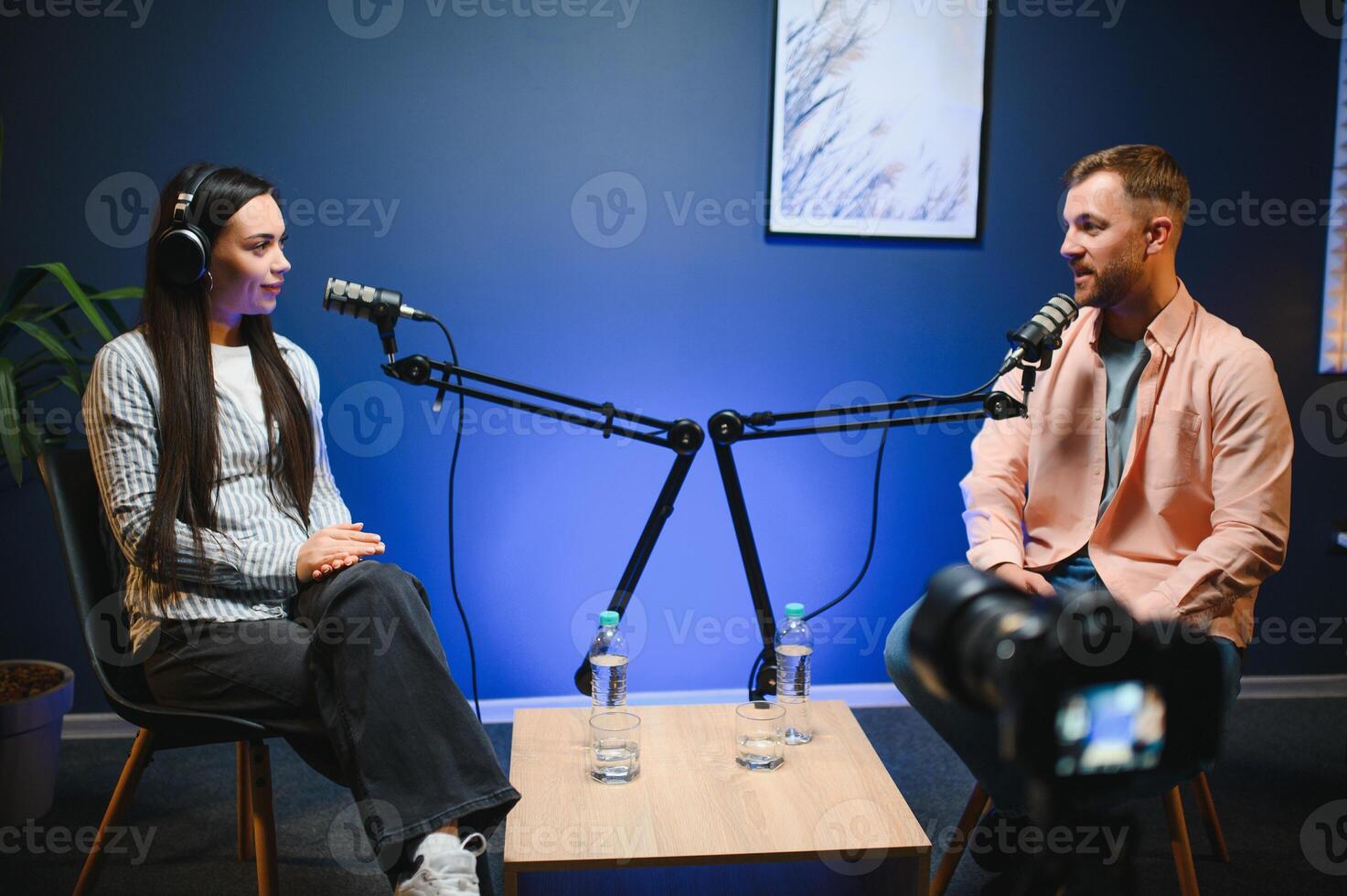 Show host interviewing woman during live stream, talking about fashion and style trends, disagreeing with her opinions. Man arguing with social media celebrity, recording podcast photo