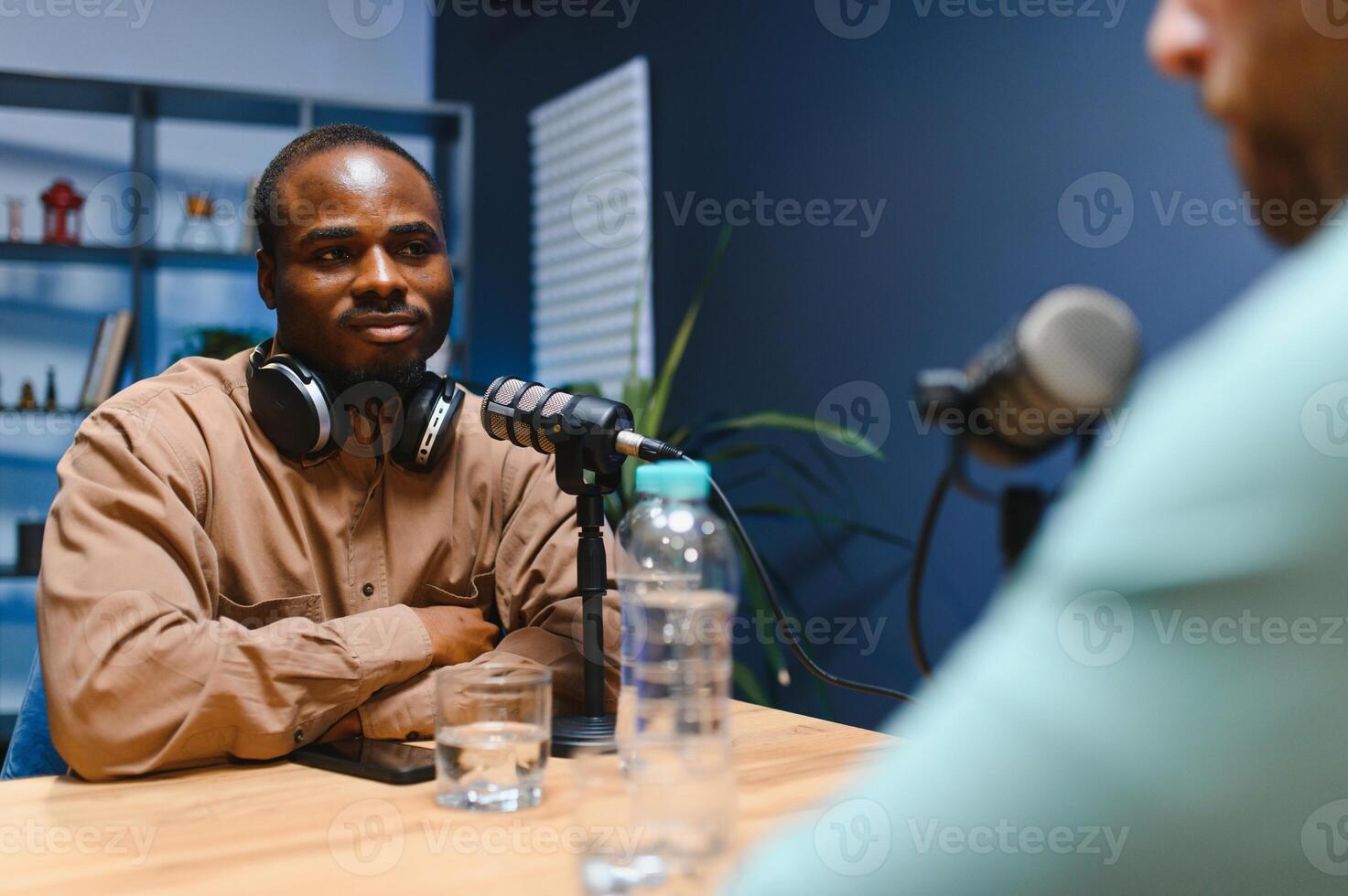 Podcast presenter having live discussion with man, streaming it for audience on internet entertainment show. Influencer enjoying chat with guest photo