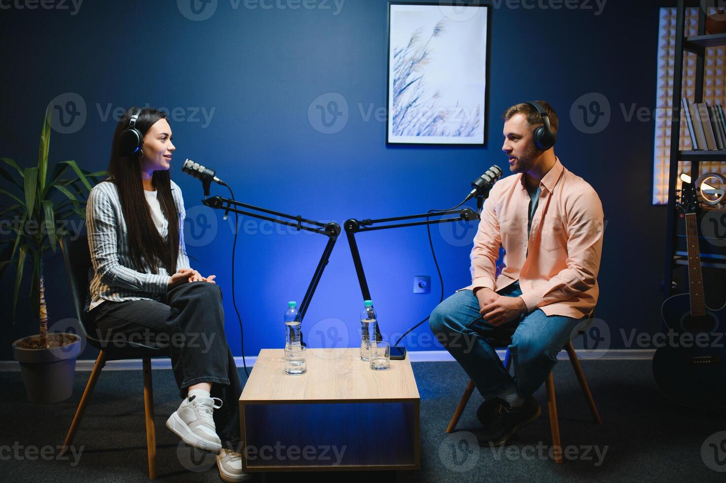 Show host interviewing woman during live stream, talking about fashion and style trends, disagreeing with her opinions. Man arguing with social media celebrity, recording podcast photo