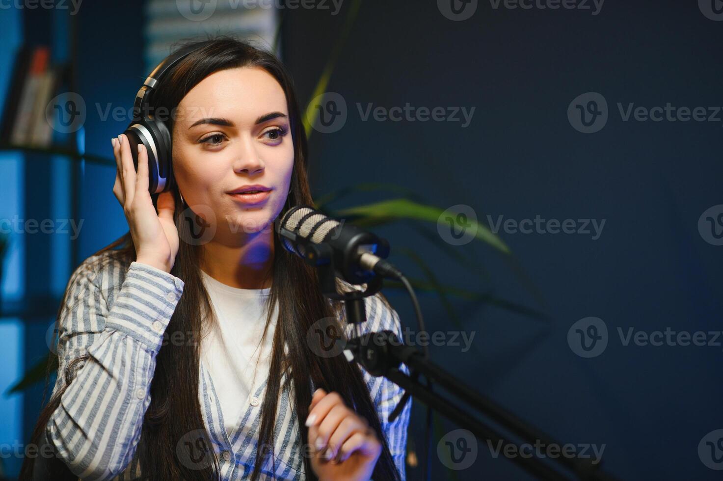Side view of successful woman hosting podcast interviewing man while recording with professional microphones, copy space photo