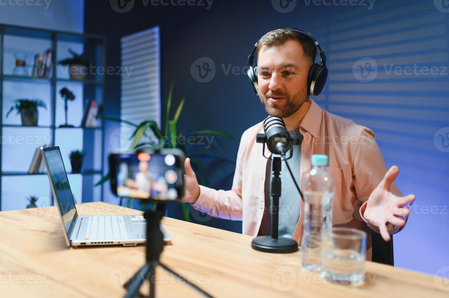 A blogger records content in his studio. The host of the blog is a young man who is very enthusiastic about telling his subscribers a story photo