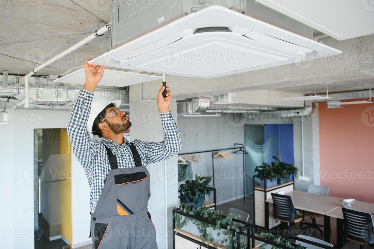 specialist repairs the air conditioner photo