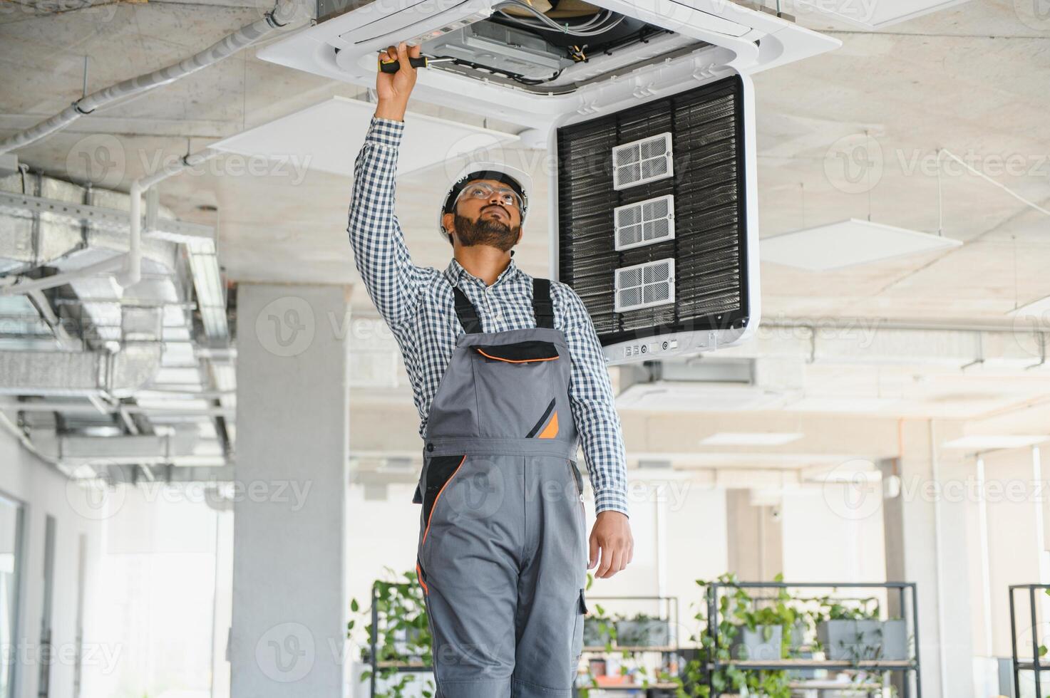 specialist repairs the air conditioner photo