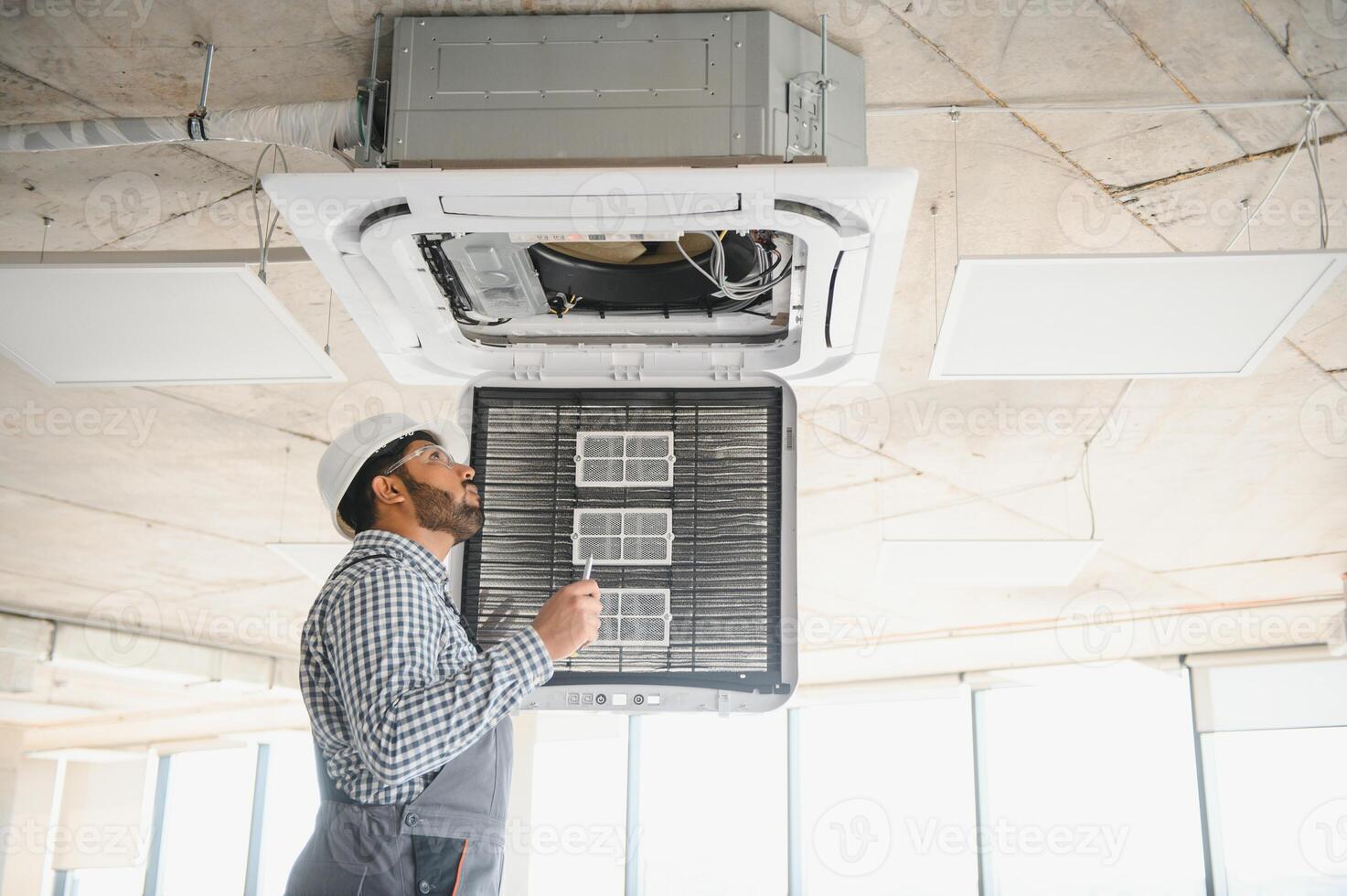 specialist repairs the air conditioner photo