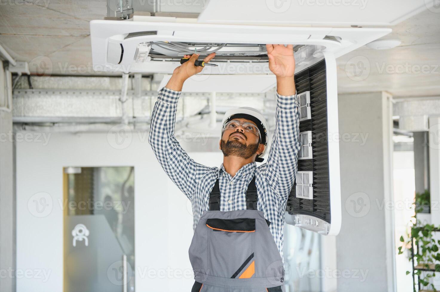 specialist repairs the air conditioner photo