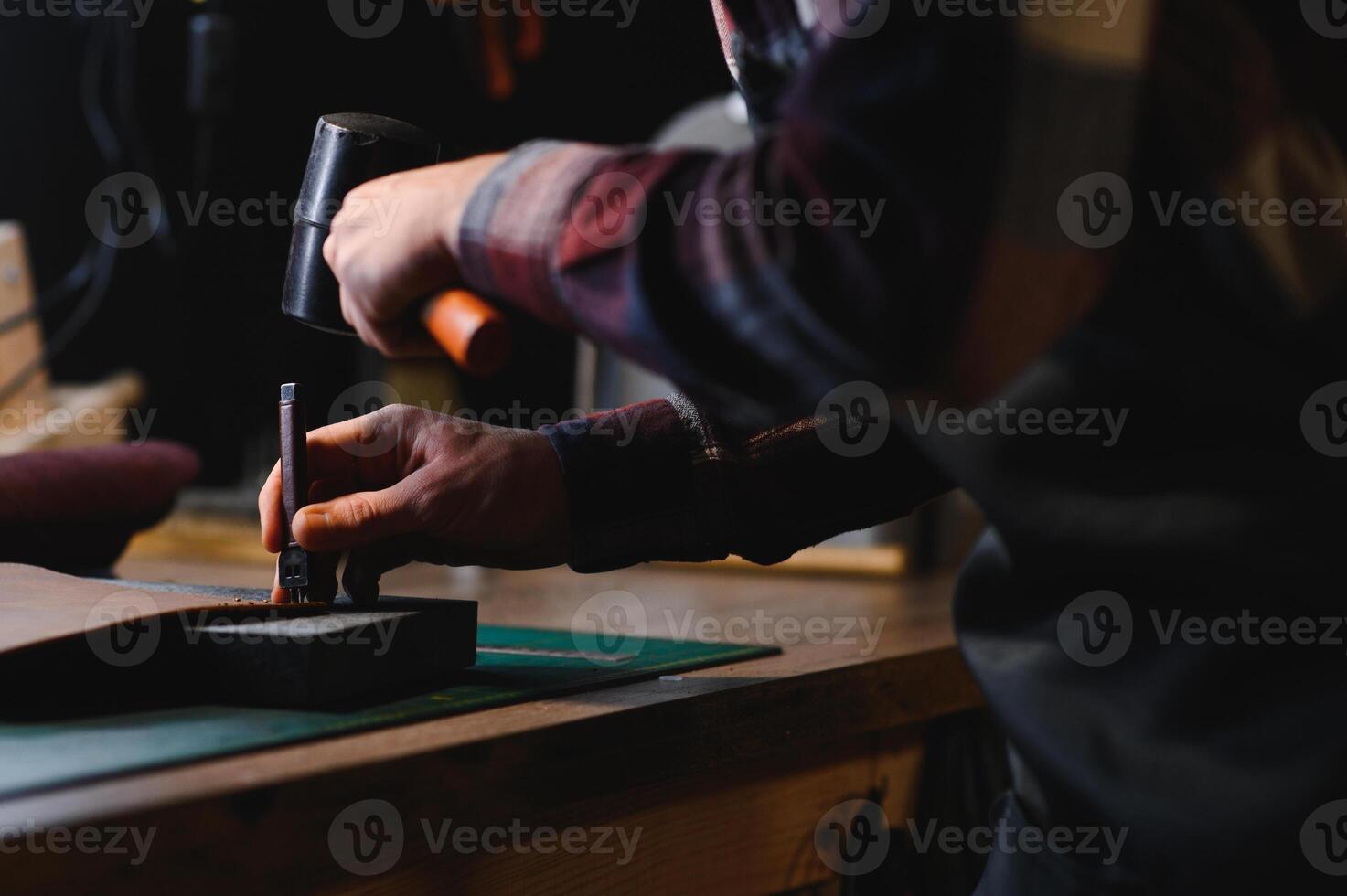 work in leather shop on dark background photo