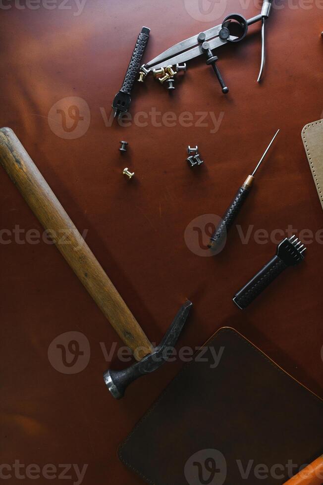 Banner tailor industry craftsman. Leather rolls and tools for handmade craft in workshop photo