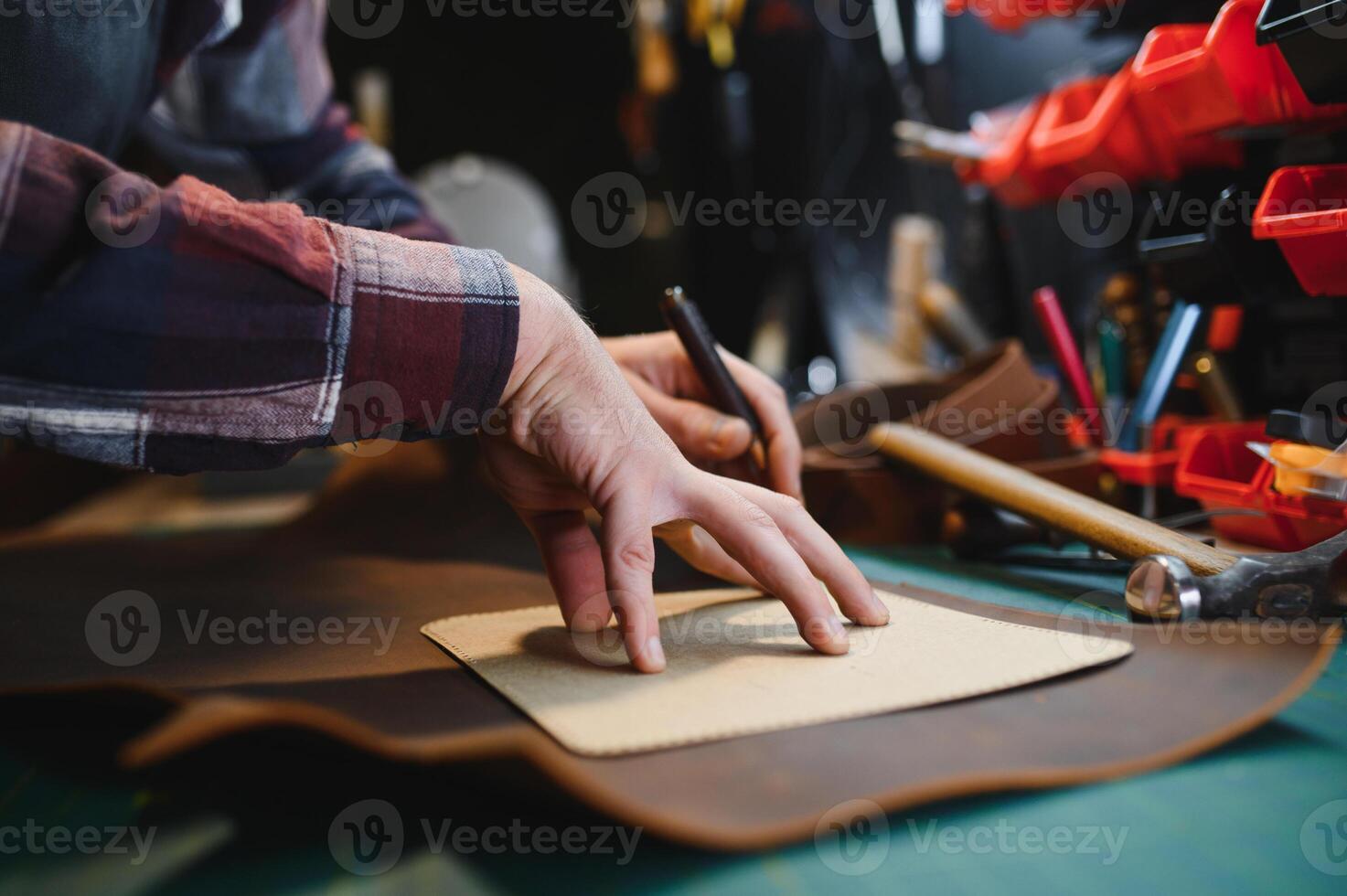 work in leather shop on dark background photo