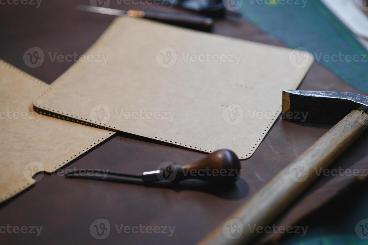 Crafting tools on natural cow leather in the tailoring workshop. Top view photo