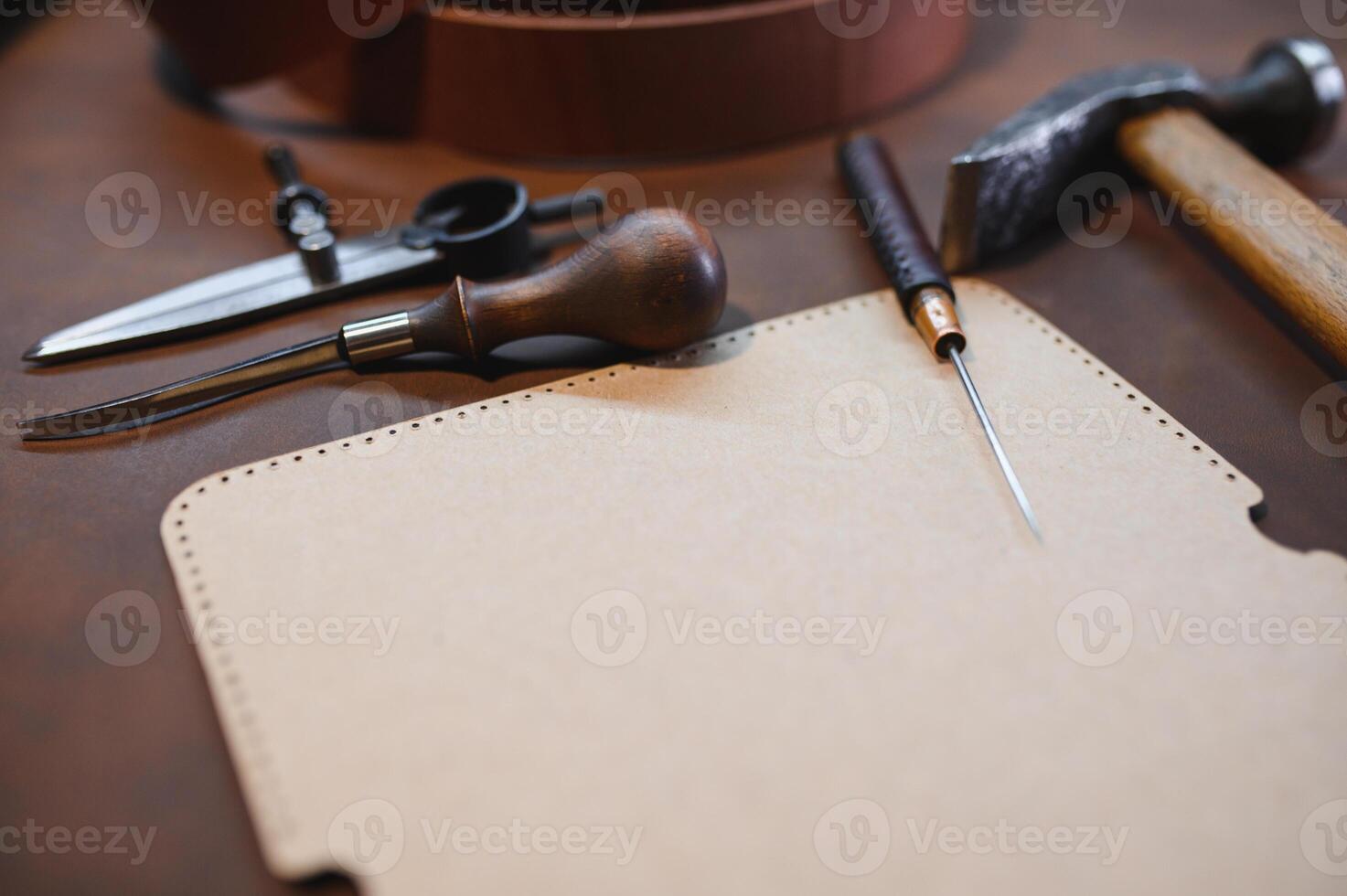 Crafting tools on natural cow leather in the tailoring workshop. Top view photo
