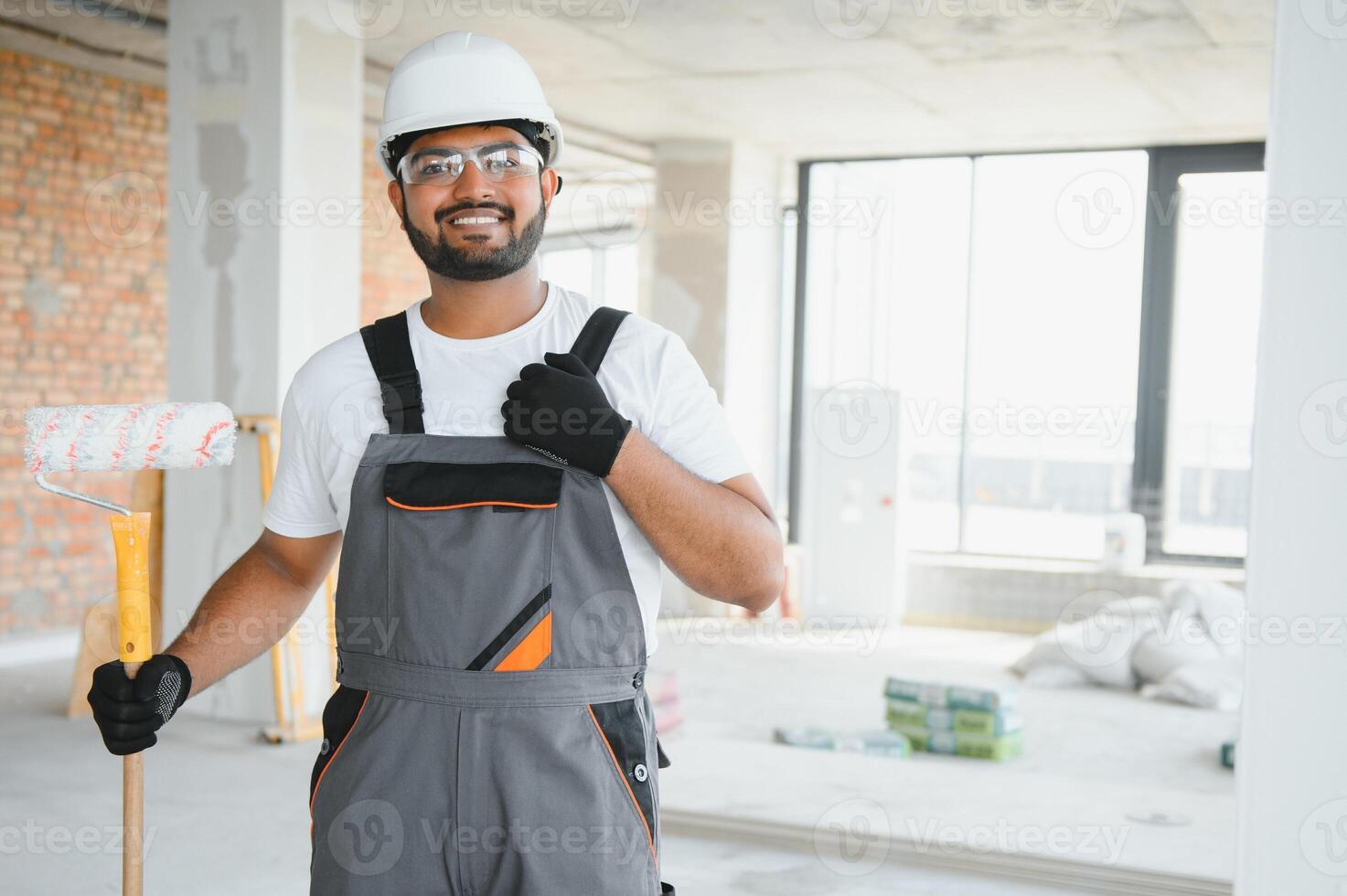painter doing painting work on wall with roller. concept of hard working, home renovation photo