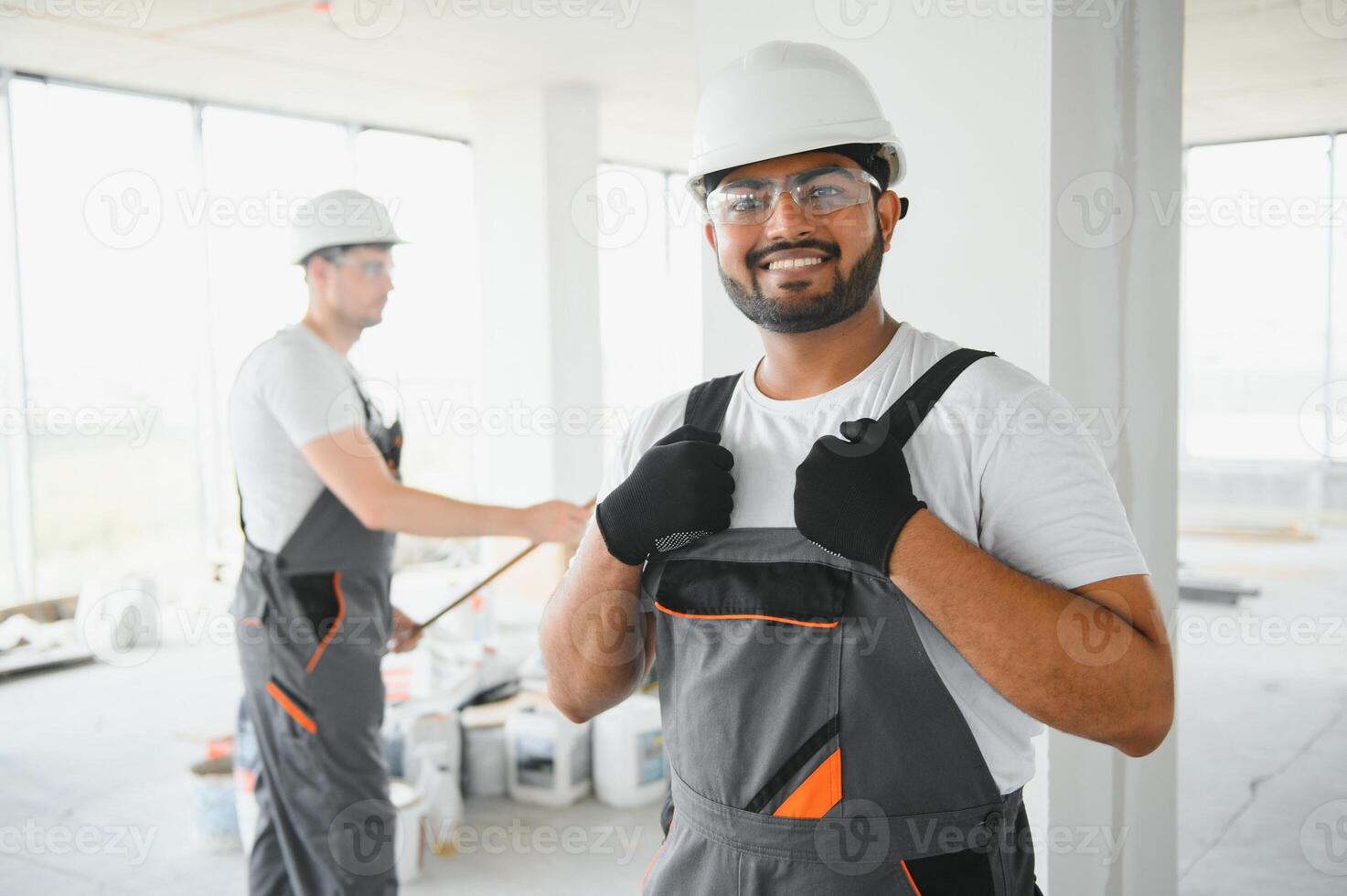 Portrait of young professional Indian worker in uniform and helmet. Construction and repair concept photo