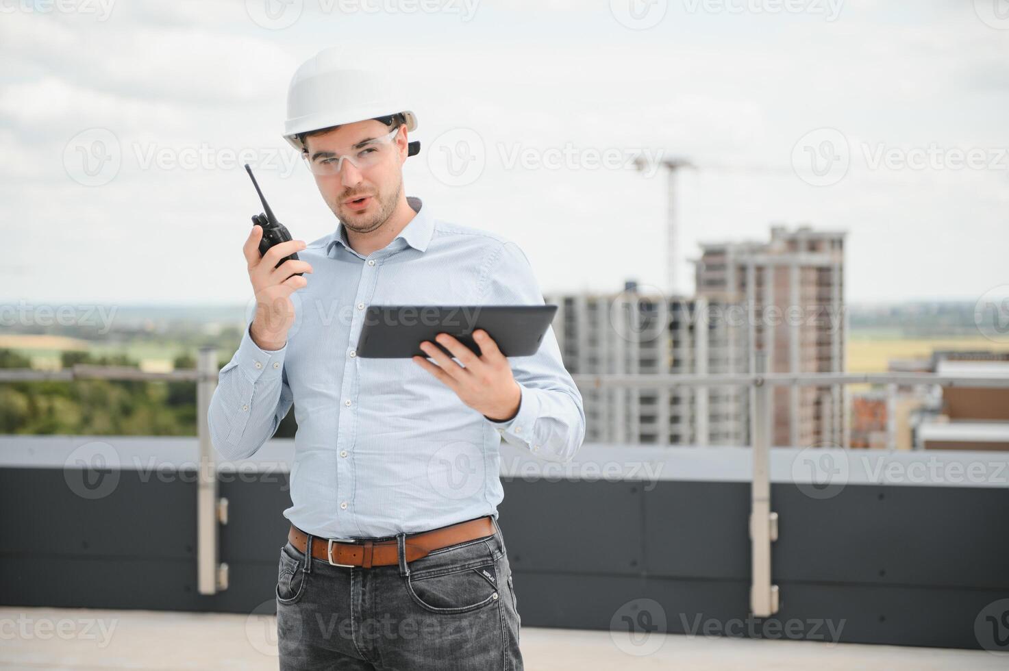 Construction concept. Portrait of a young architect at a construction site photo