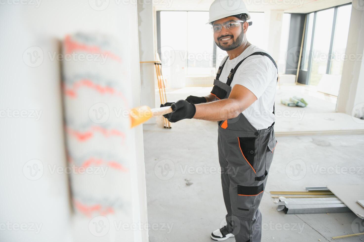 painter doing painting work on wall with roller. concept of hard working, home renovation photo