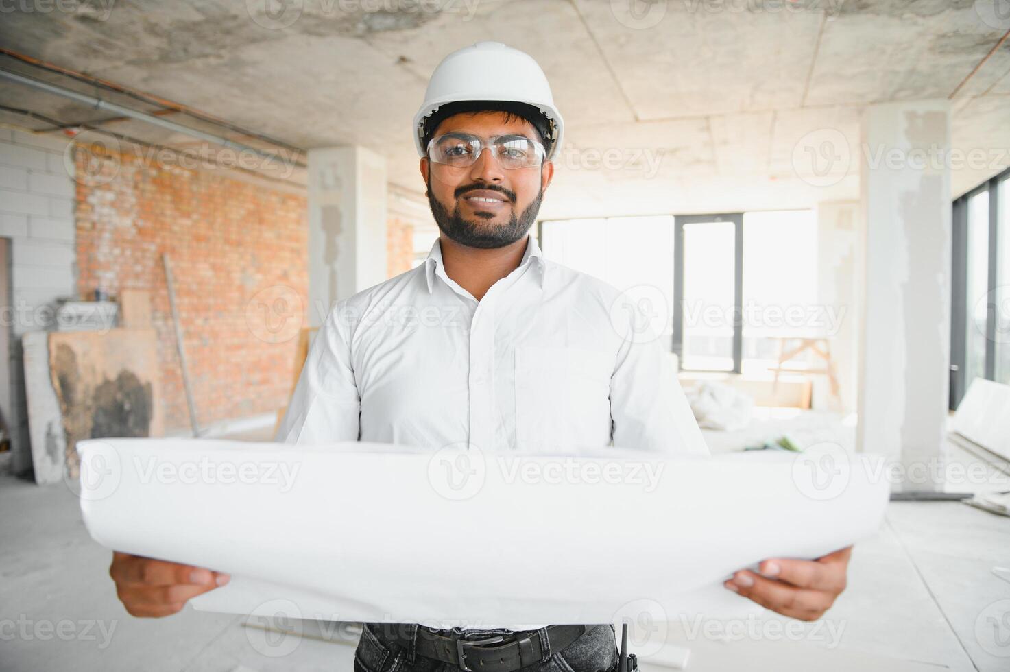 Construction concept. Portrait of a young architect at a construction site photo