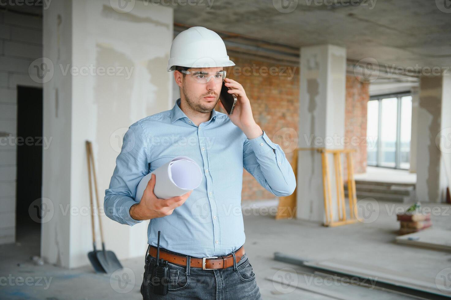 Architect in hard hat with draft photo