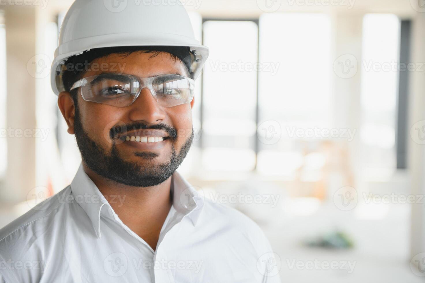 Construction concept. Portrait of a young architect at a construction site photo