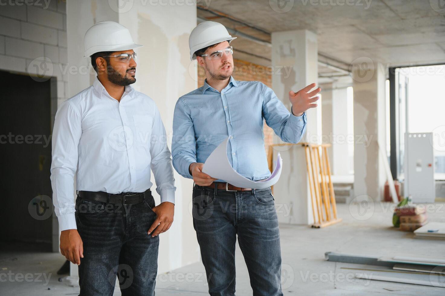 two architect engineers are walking in a constructed office building. implementation of the project photo