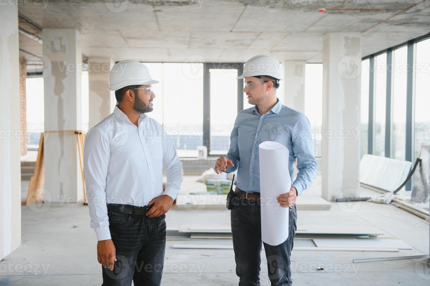 two architect engineers talking in a constructed office building photo