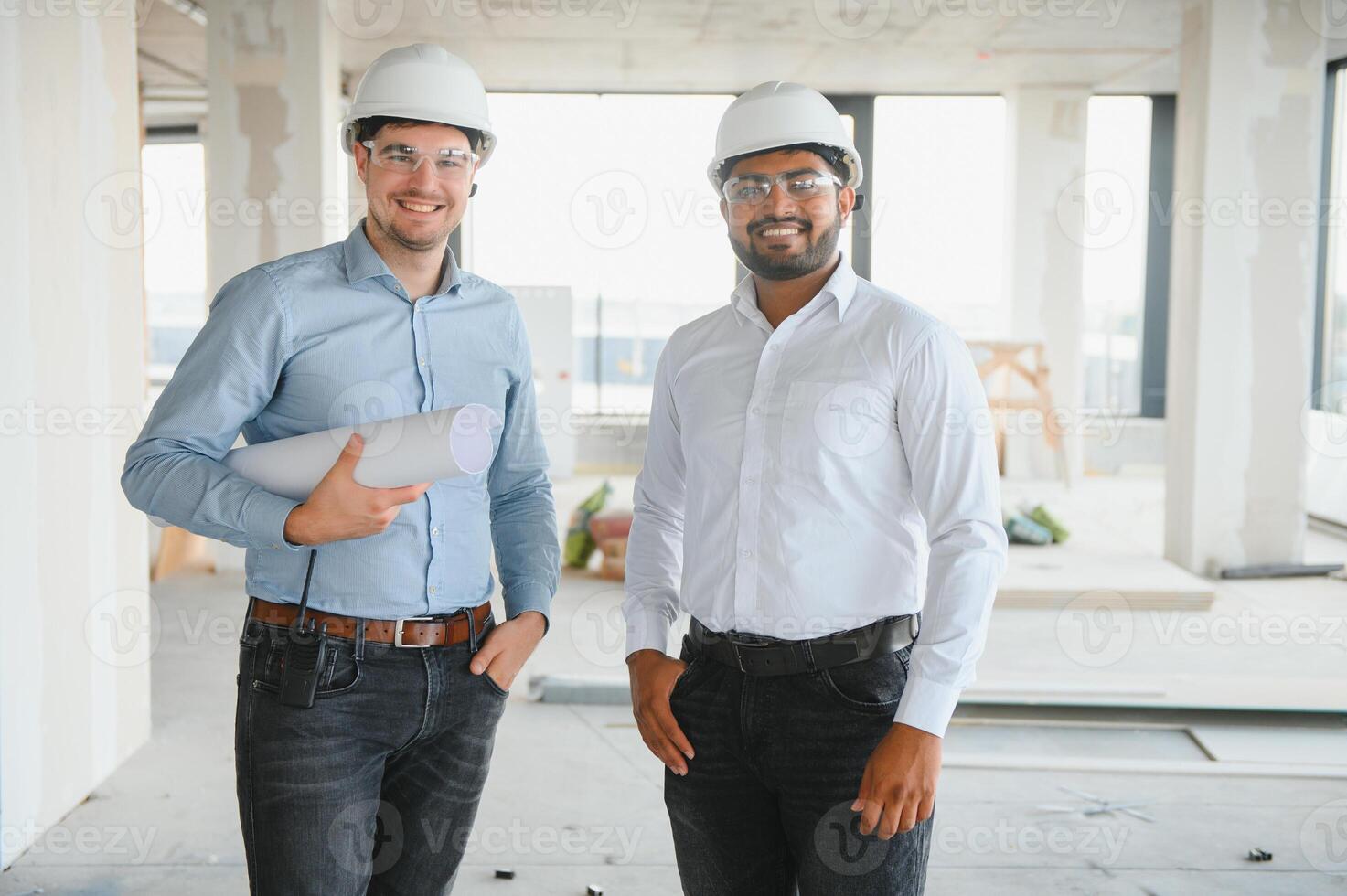 two architect engineers are walking in a constructed office building. implementation of the project photo