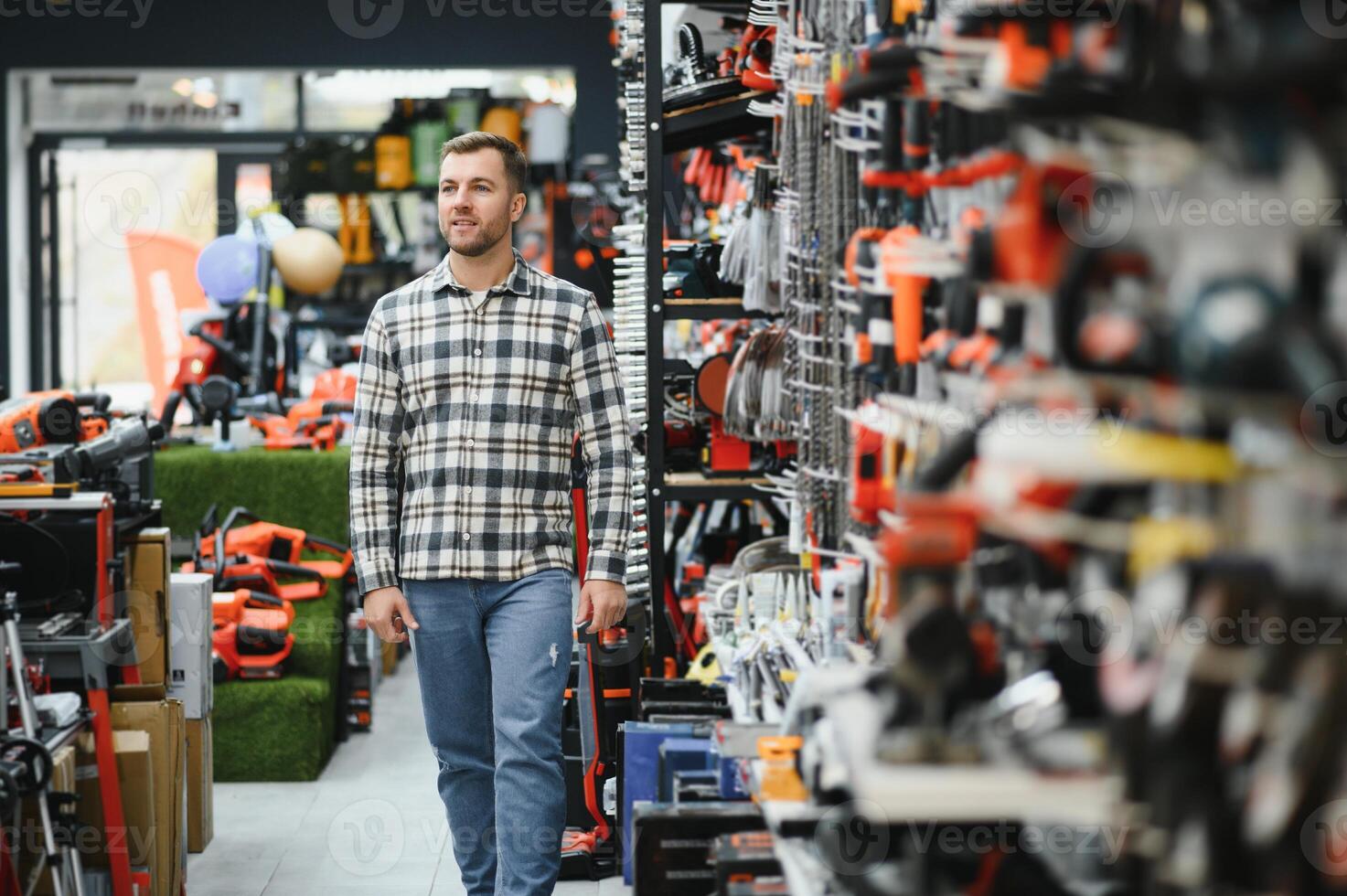 A man chooses a power tool in a hardware store photo
