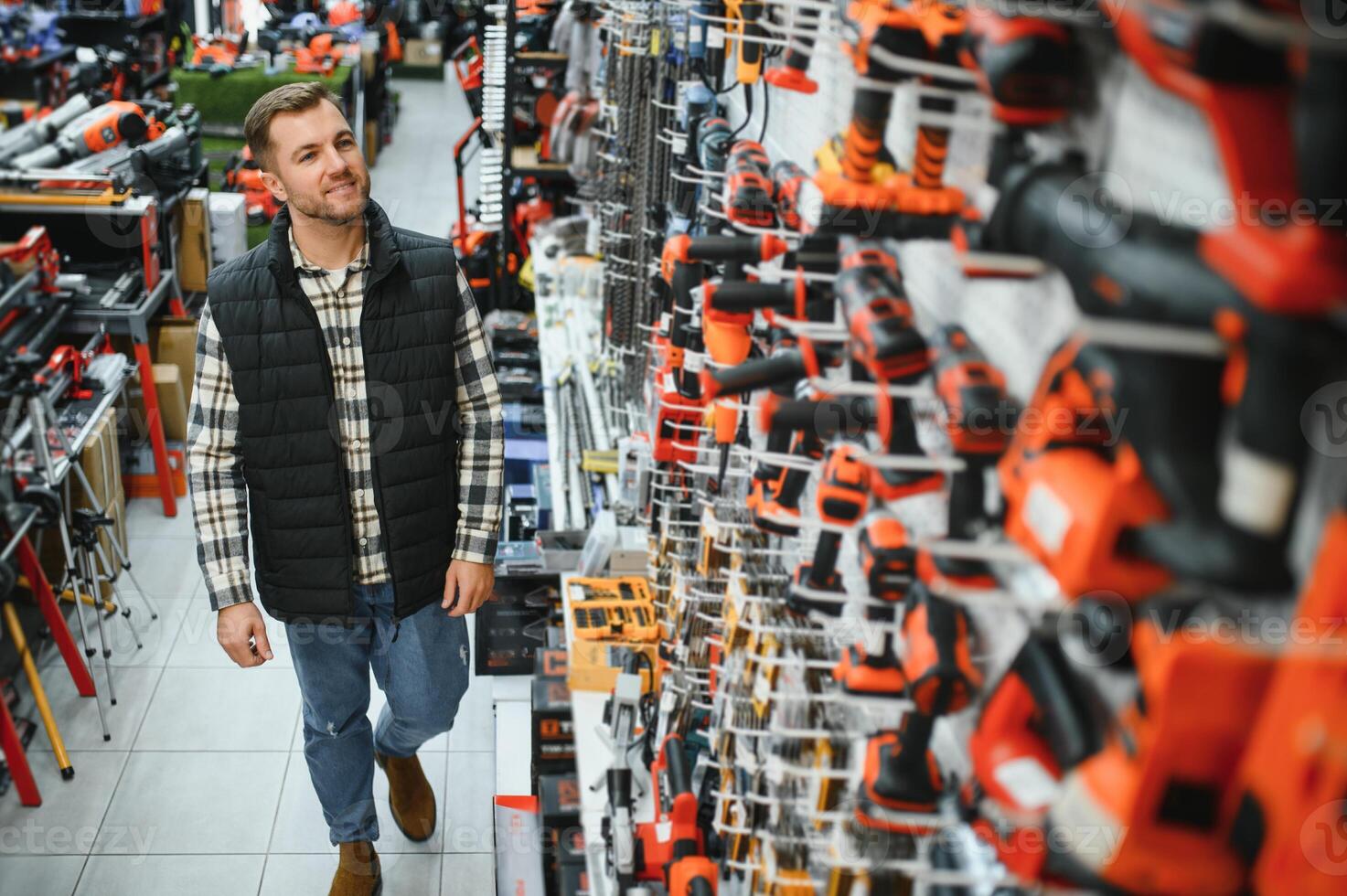 A man chooses a power tool in a hardware store photo