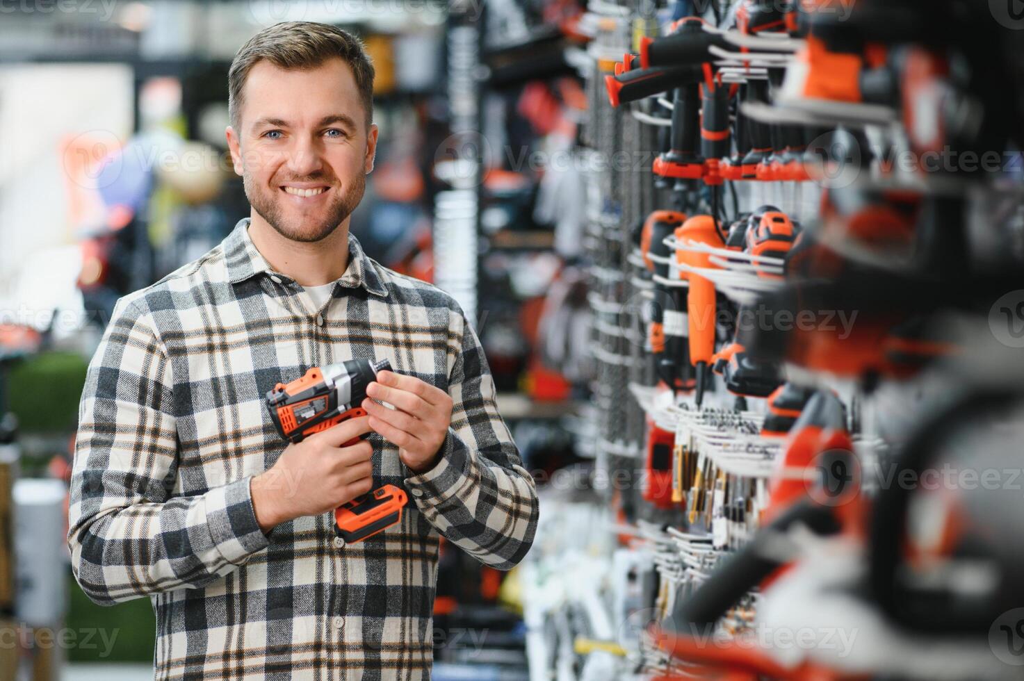 A man chooses a power tool in a hardware store photo