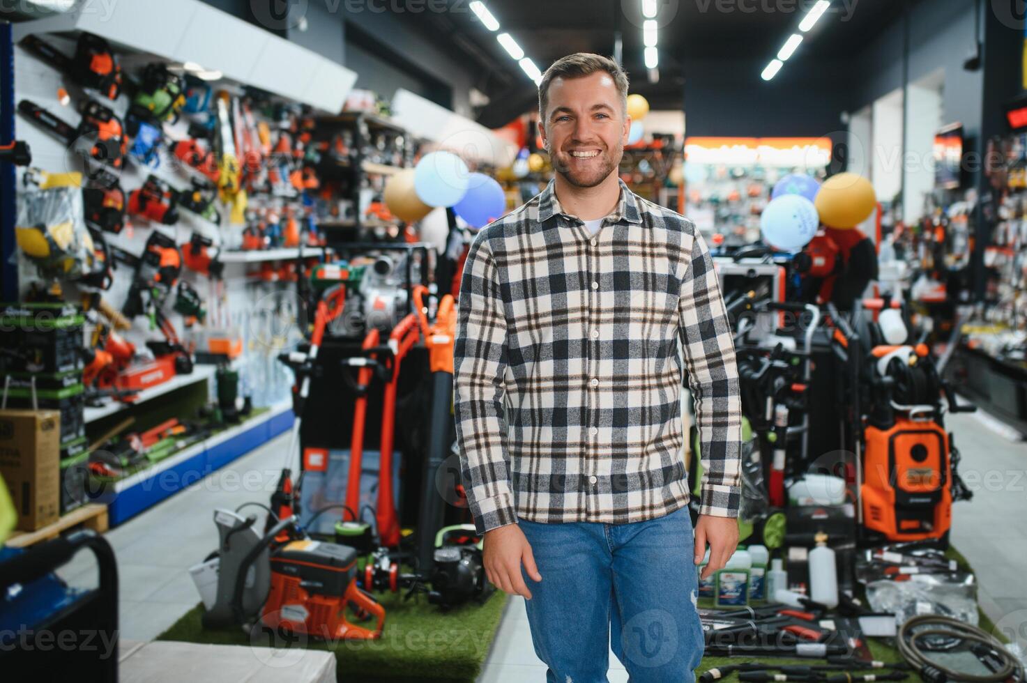 A man in a hardware store choosing a tool photo