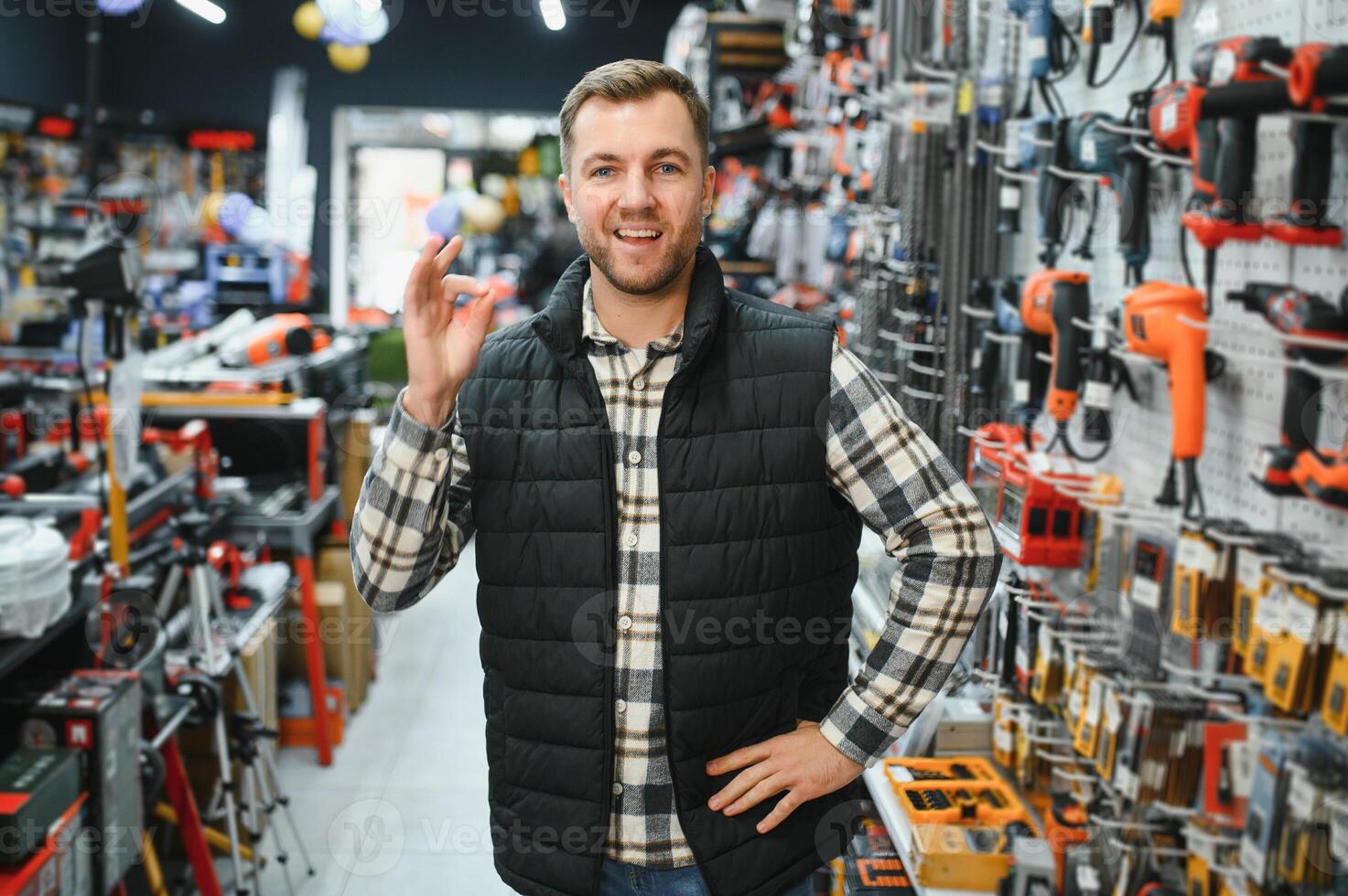 A man chooses a power tool in a hardware store photo