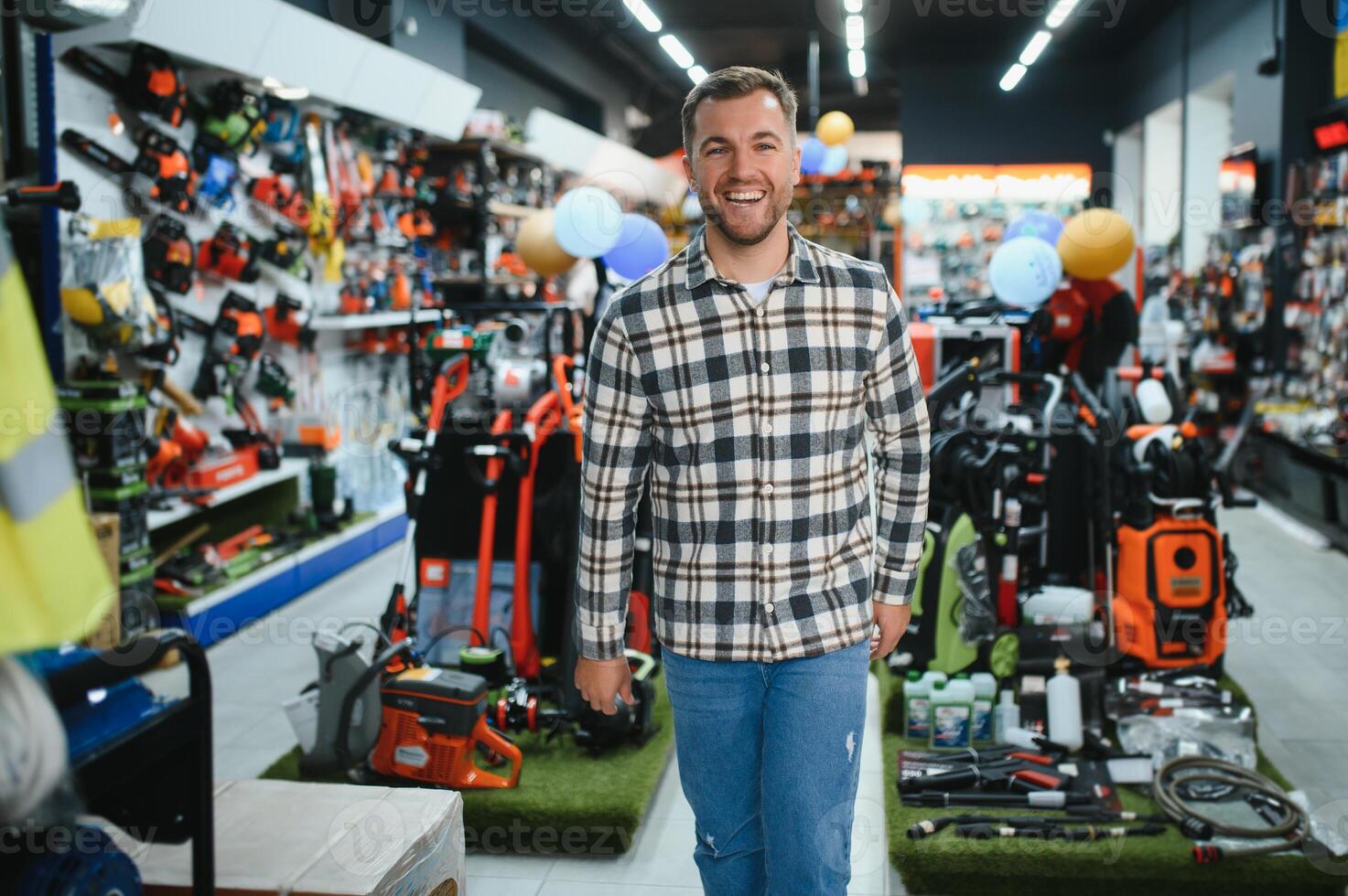 A man in a hardware store choosing a tool photo