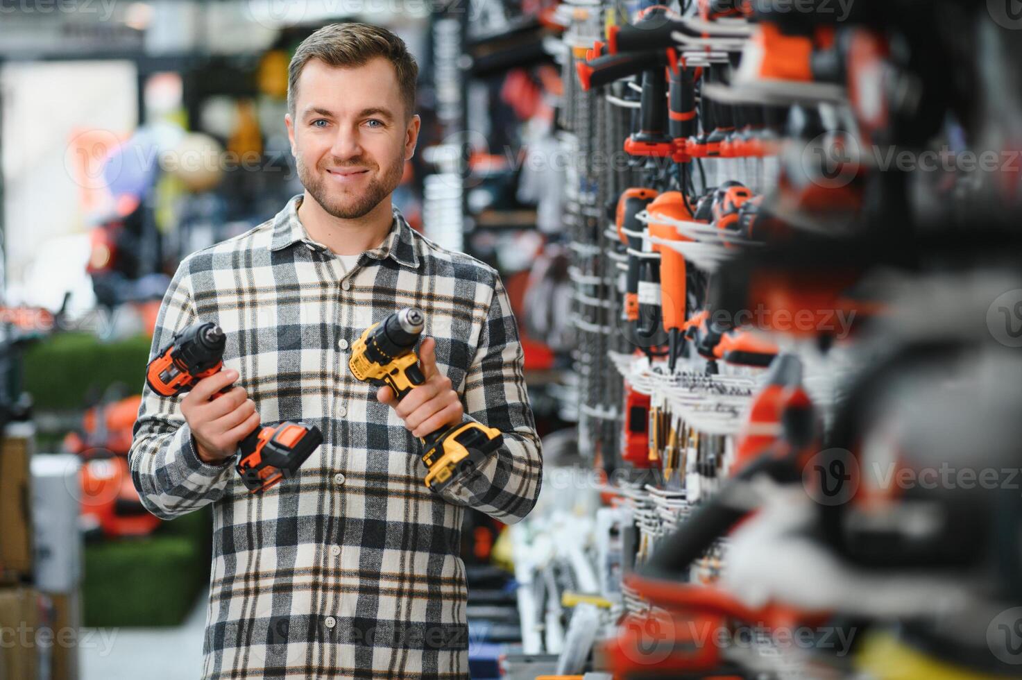 A man chooses a power tool in a hardware store photo